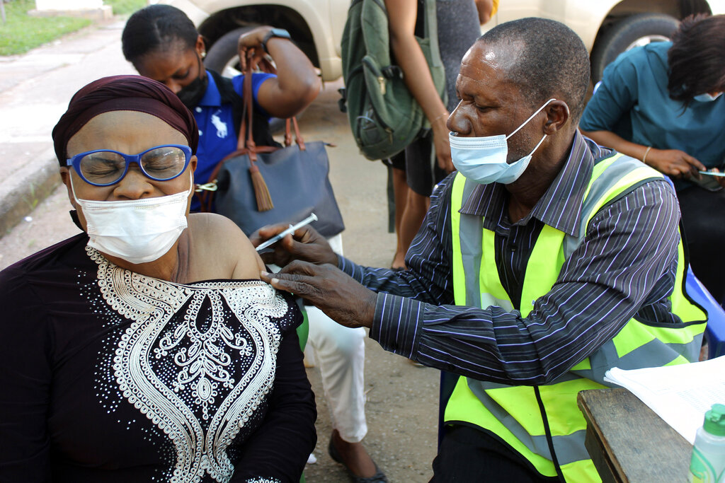 A woman receives a coronavirus vaccine jab in Abuja, Nigeria,