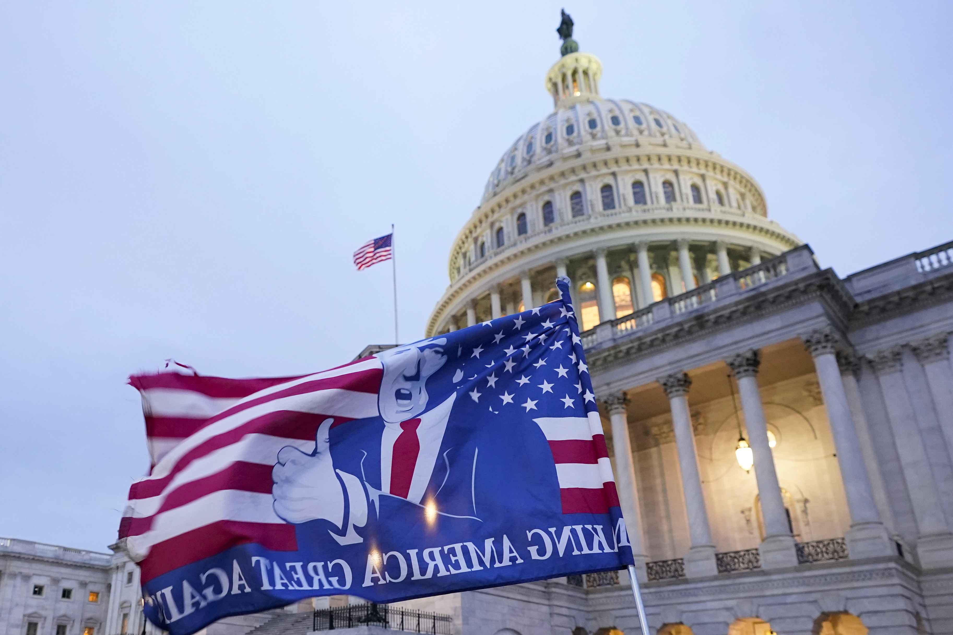 A flag depicting then-President Donald Trump flies on the East Front of the U.S. Capitol on January 6, 2021, in Washington