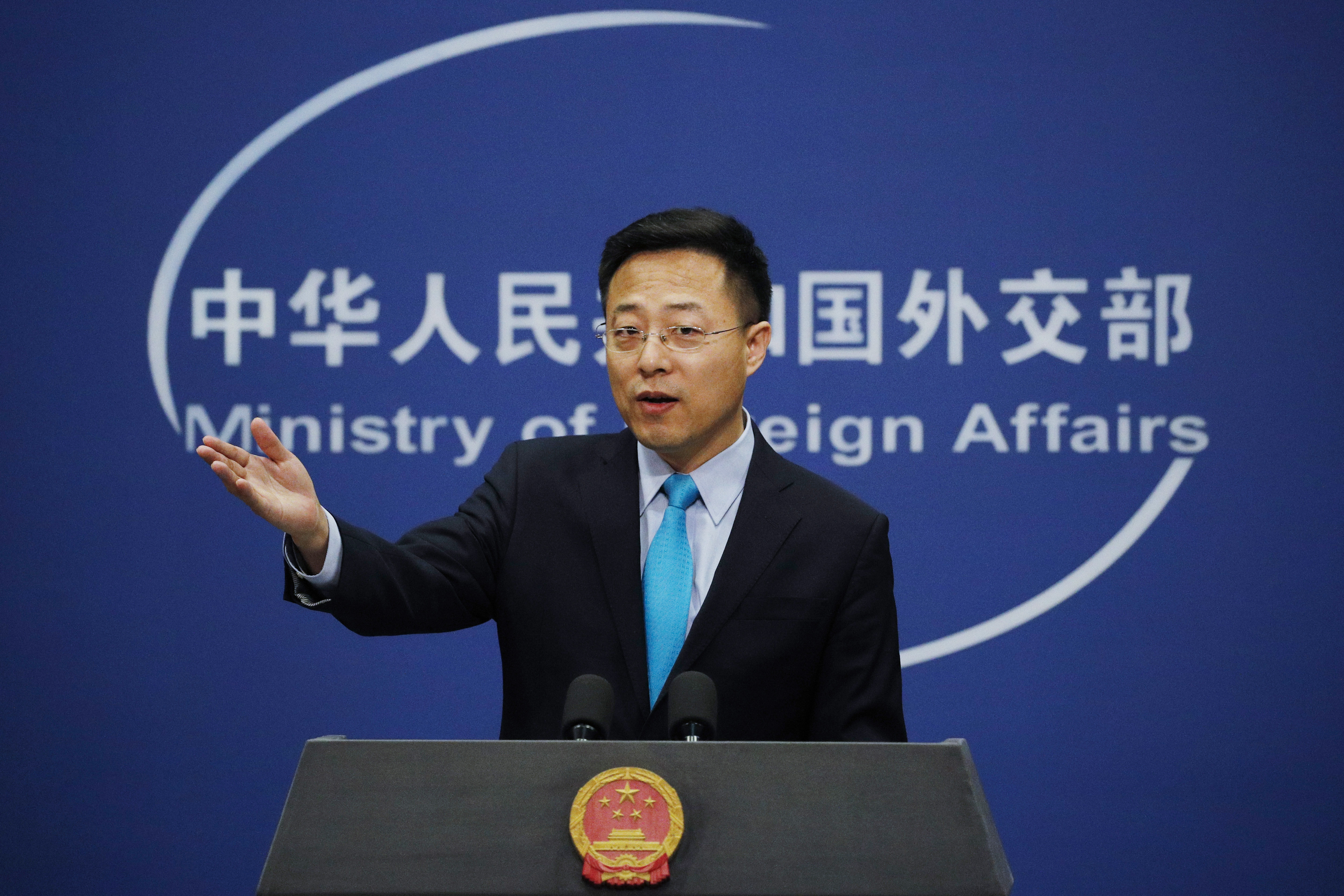 Lijian gestures as he speaks during a daily briefing at his ministry in Beijing