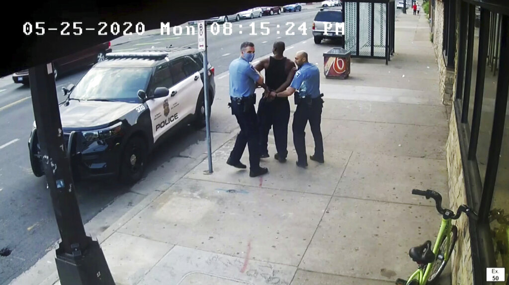 image from video shows Minneapolis police Officers Thomas Lane, left and J. Alexander Kueng, right, escorting George Floyd, center, to a police vehicle outside Cup Foods in Minneapolis.