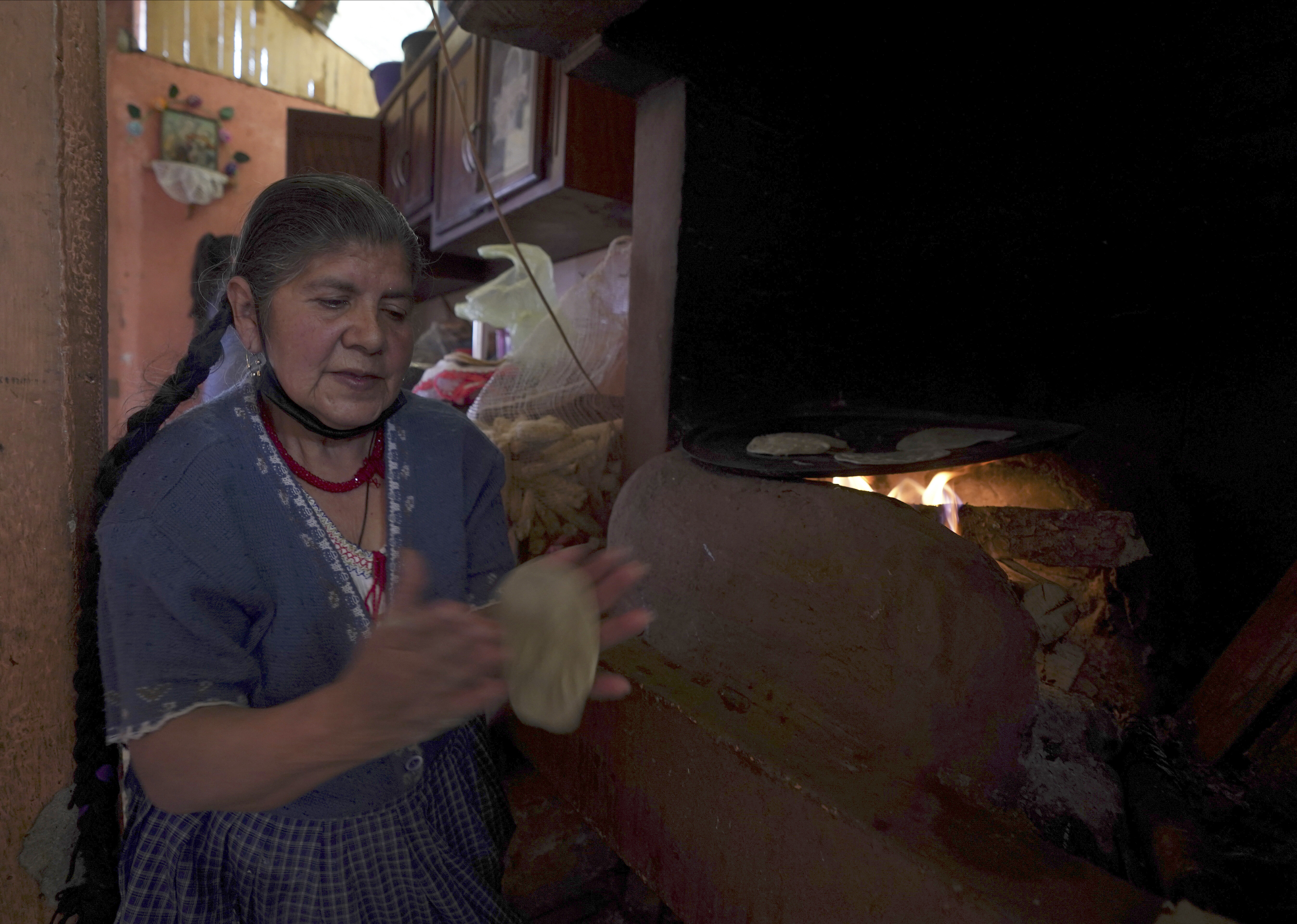 A woman makes tortillas in the Puerpecha Indigenous community of Comachuen, Mexico