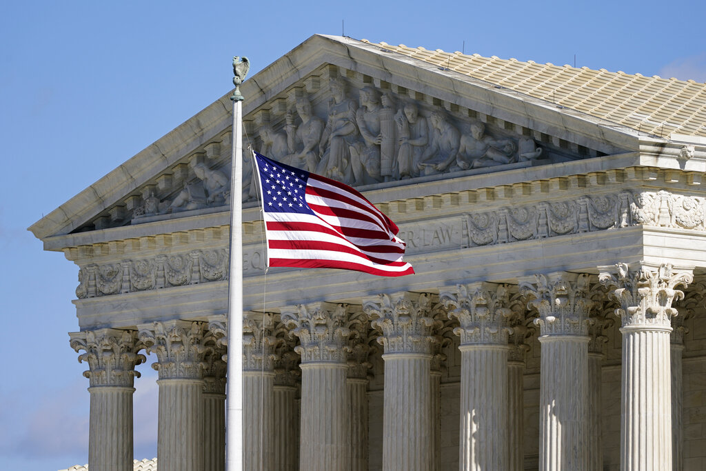 An American flag waves in front of the Supreme Court building on Capitol Hill in Washington, DC.