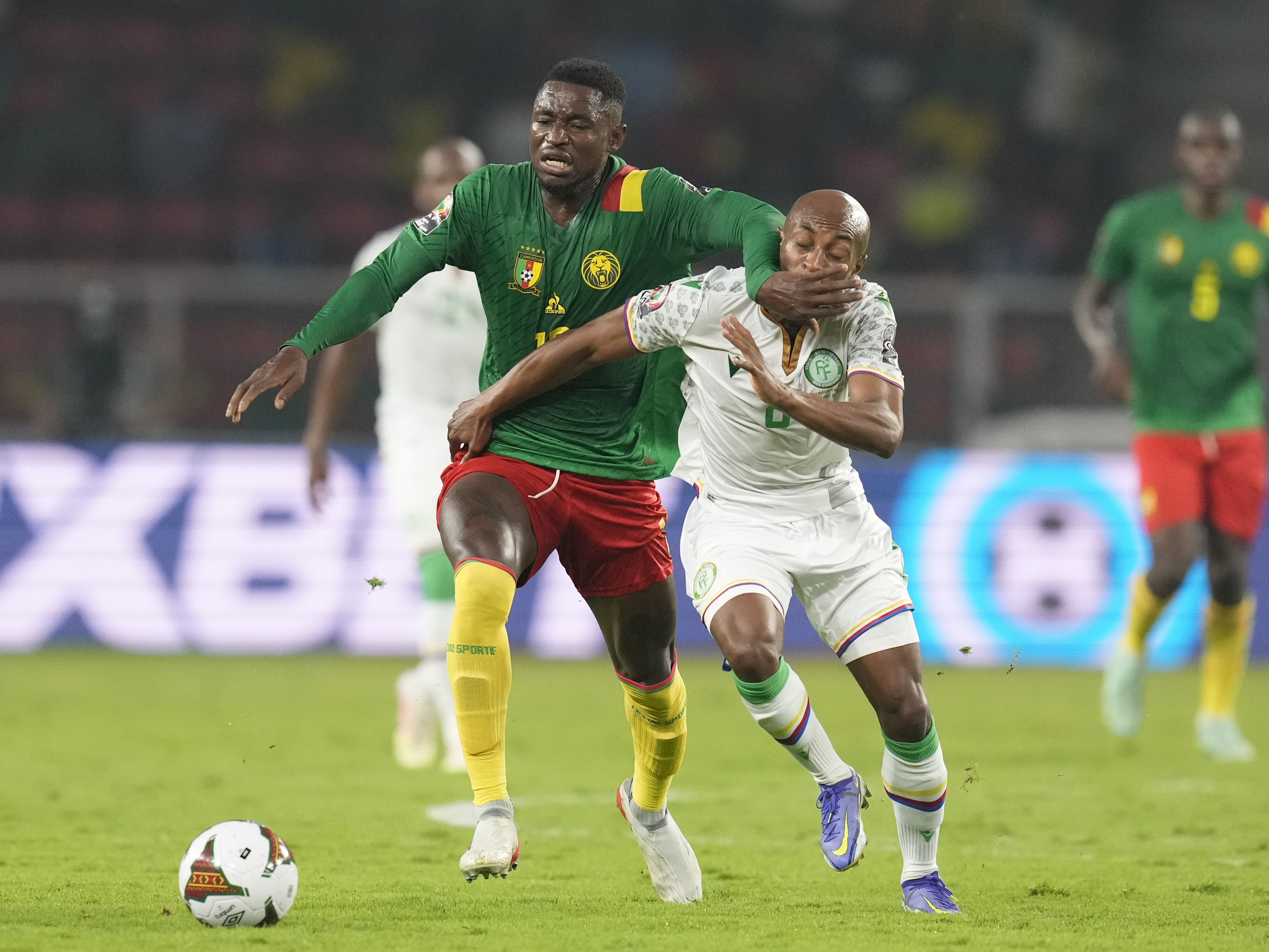 Comoros' Fouad Bachirou, right, is challenged by Cameroon's Martin Hongla during the African Cup of Nations