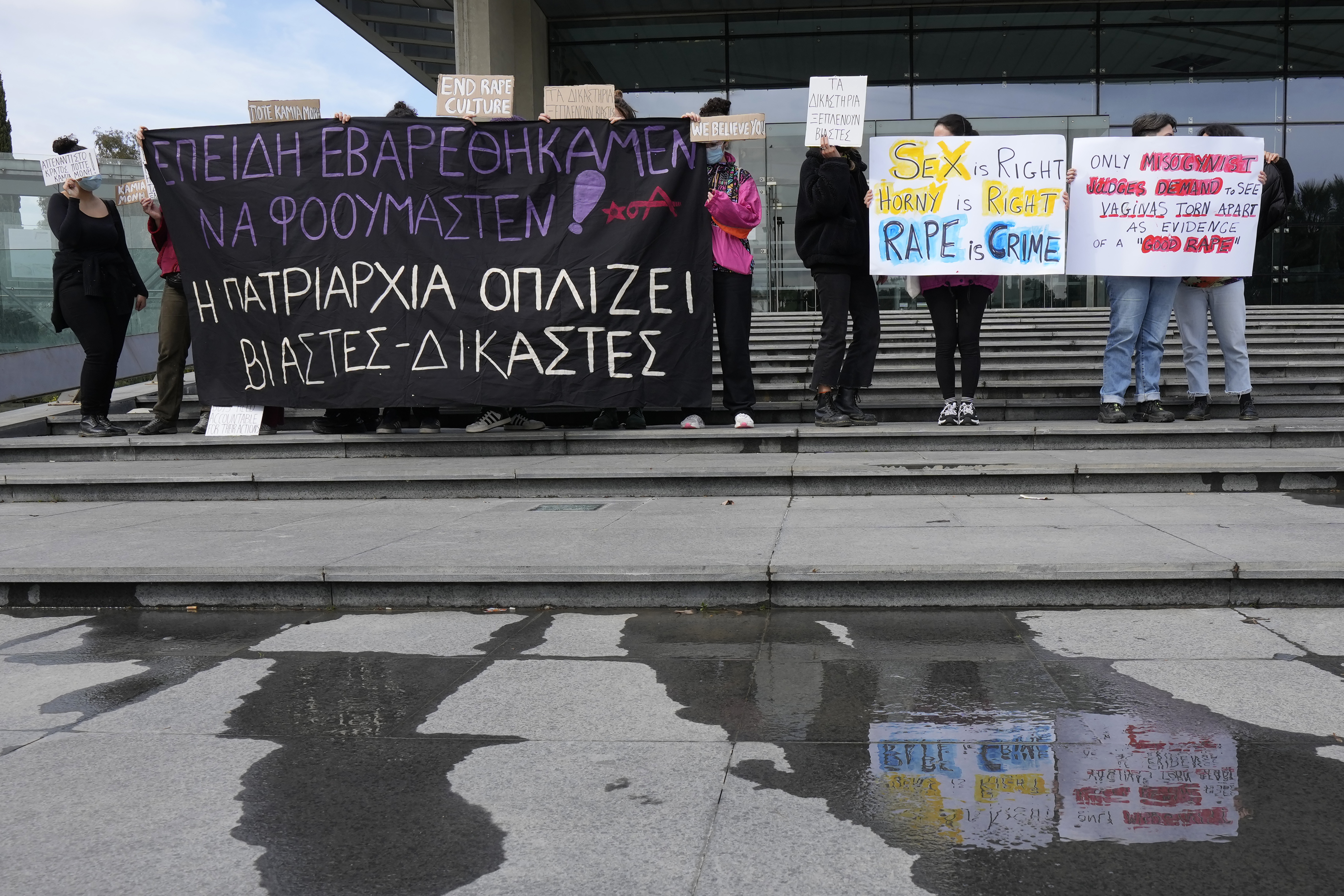 Protesters hold banners in support of a British woman