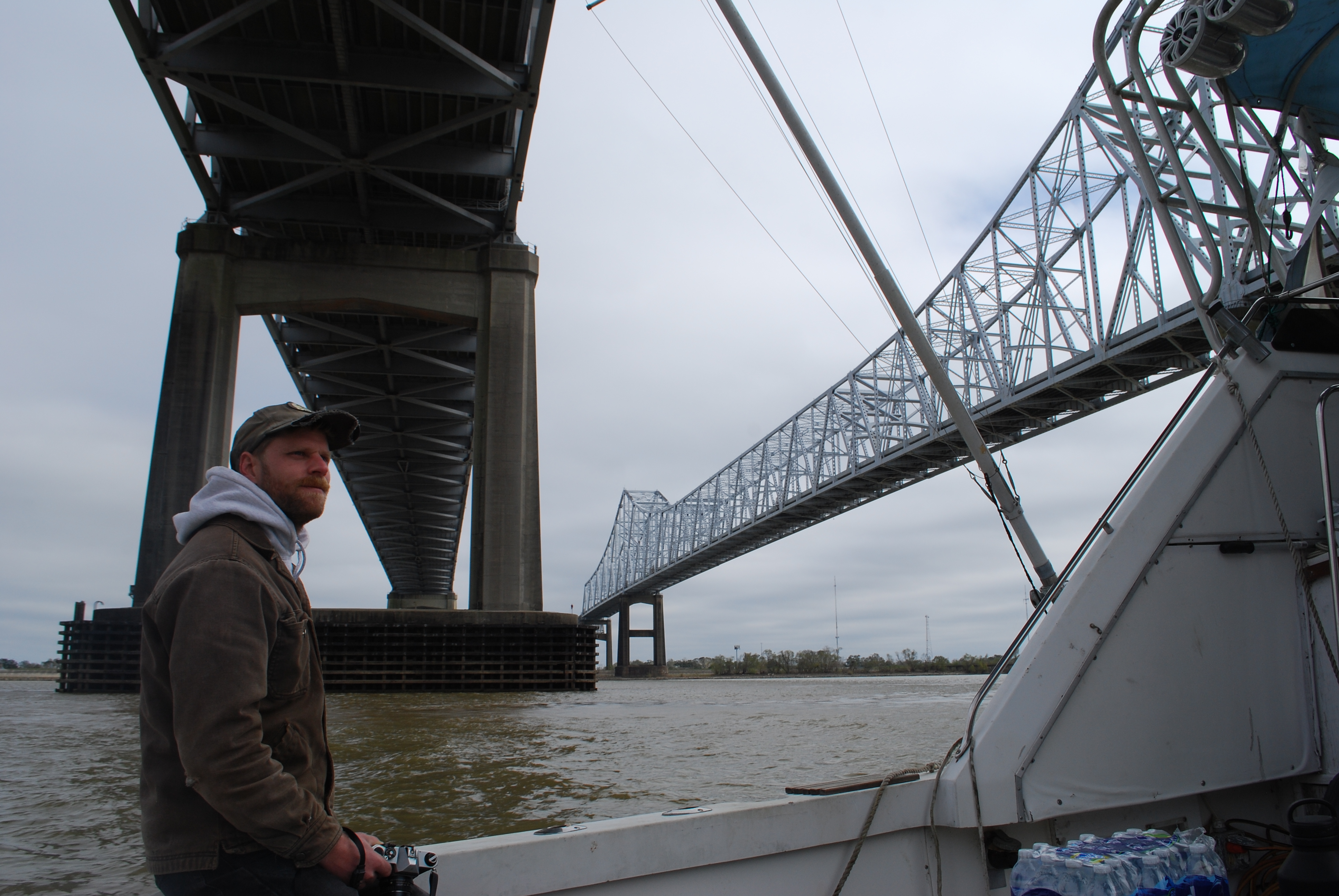 Deckhand Luke LaCava passes under the Crescent City Connection spanning the Mississippi River