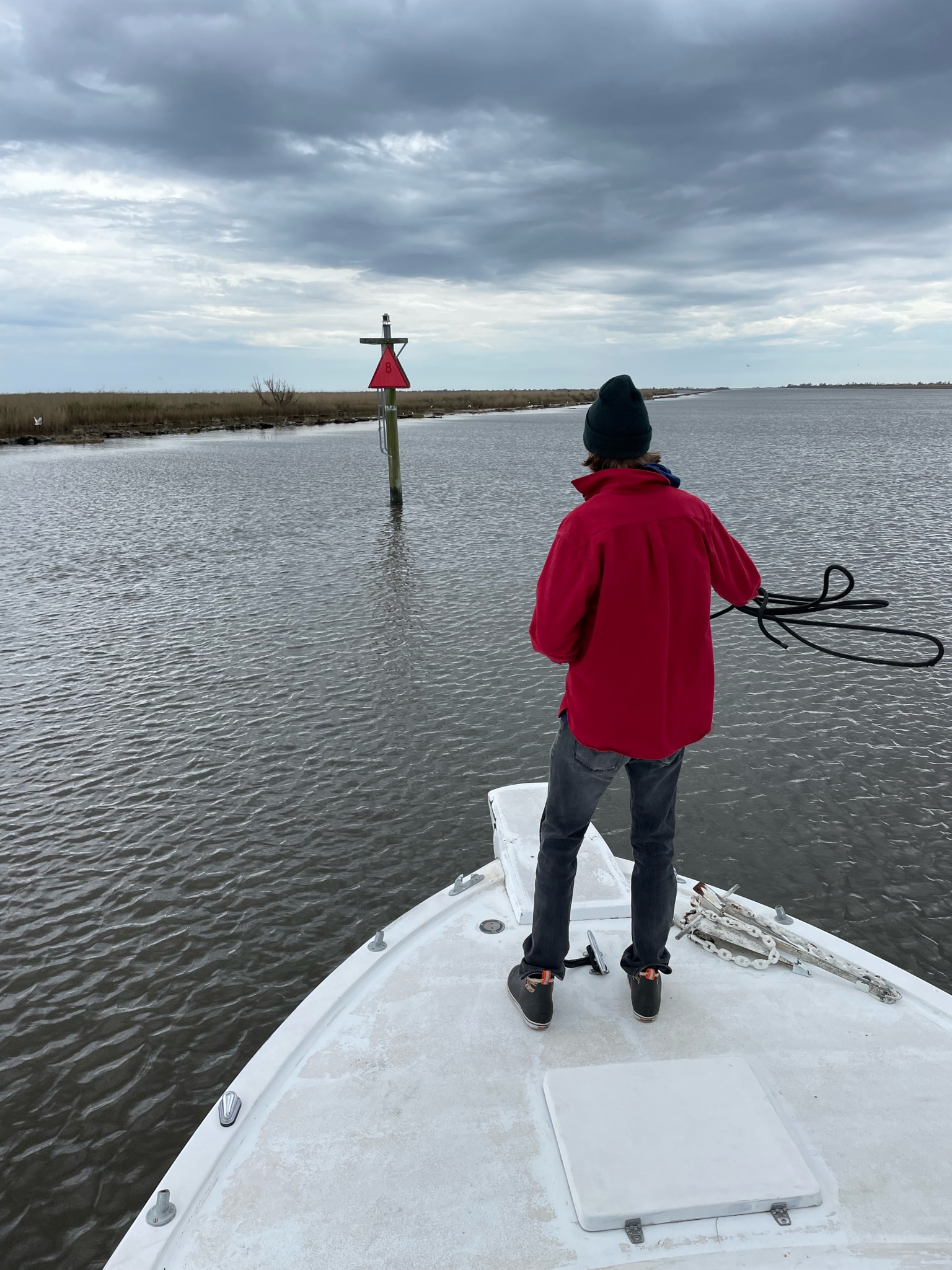 Deckhand Mitchell Jarrett prepares to throw a line and tie Les Bons Temps to a piling in the Barataria Waterway so the crew can check the propellor shaft