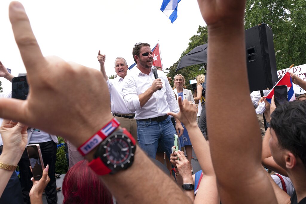 Rep. Mario Diaz-Balart, R-Fla., left, points to the crowd as Rep. Dan Crenshaw, R-Texas, speaks during a protest of the Cuban government, Monday, July 26, 2021, at Lafayette Park near the White House.