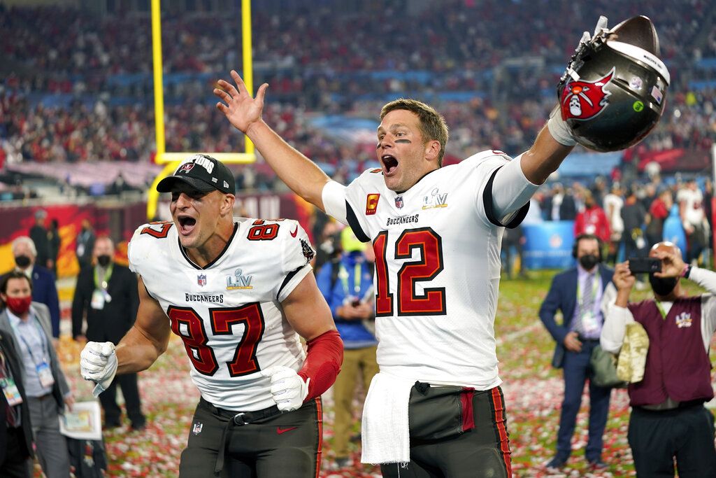 Tampa Bay Buccaneers tight end Rob Gronkowski, left, and quarterback Tom Brady (12) celebrate after the NFL Super Bowl 55 football game against the Kansas City Chiefs in Tampa, Florida in 2021. 