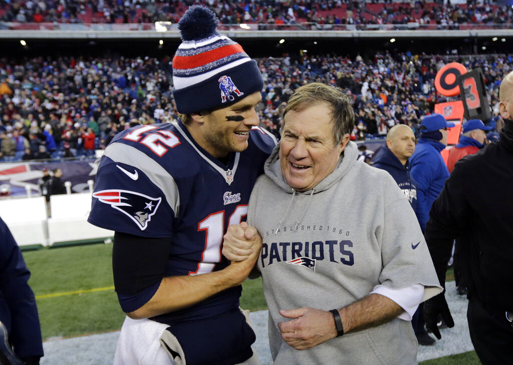 New England Patriots quarterback Tom Brady, left, celebrates with head coach Bill Belichick after defeating the Miami Dolphins 41-13 in an NFL football game Sunday, Dec. 14, 2014, in Foxborough, Massachussetts.