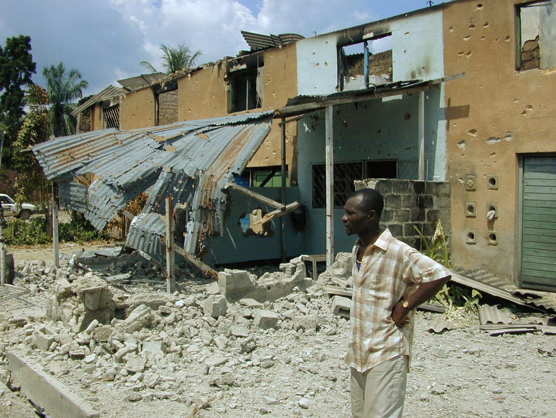 A Congolese man looks at the destruction of the Tshopo neighborhood of Kisangani