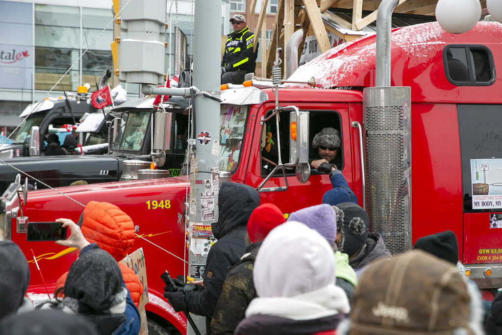 A crowd stands next to a truck in Ottawa
