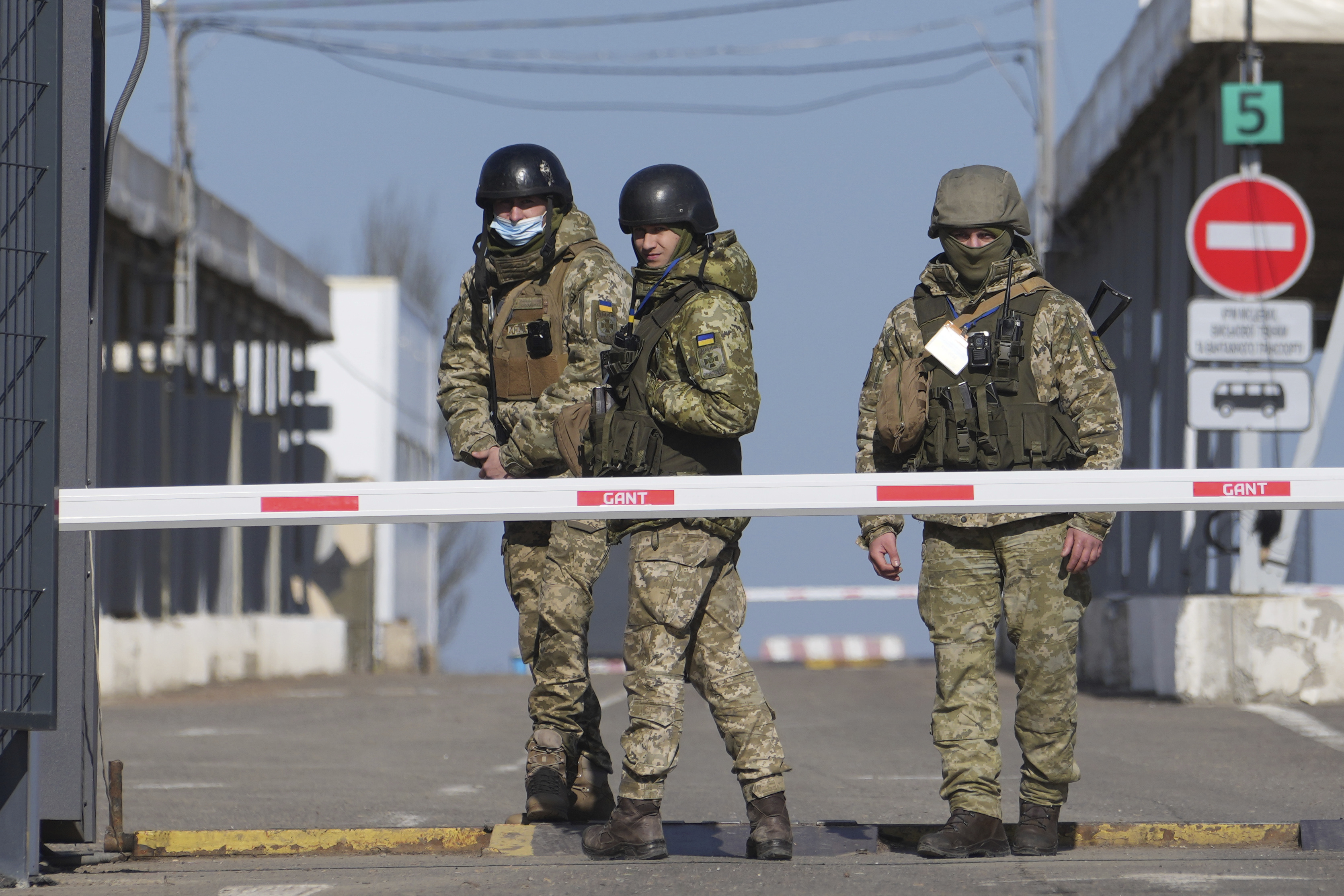 Ukrainian border guards stand at a checkpoint from territory controlled by Russia-backed separatists to the territory controlled by Ukrainian forces in eastern Ukraine