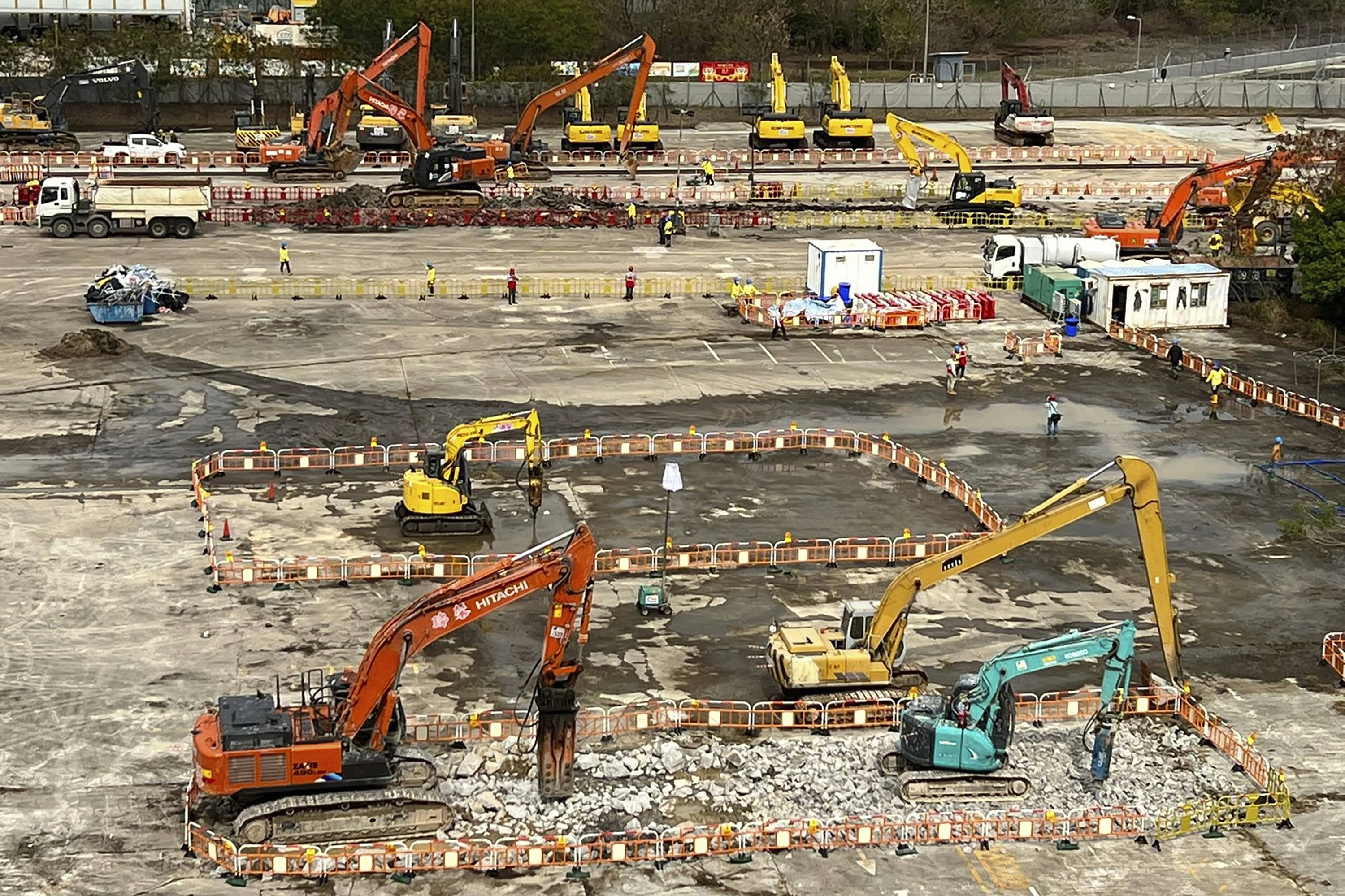 Hong Kong is building temporary medical facilities to help deal with the surge in COVID-19 cases amid resentment at its commitment to a China-style Zero COVID policy