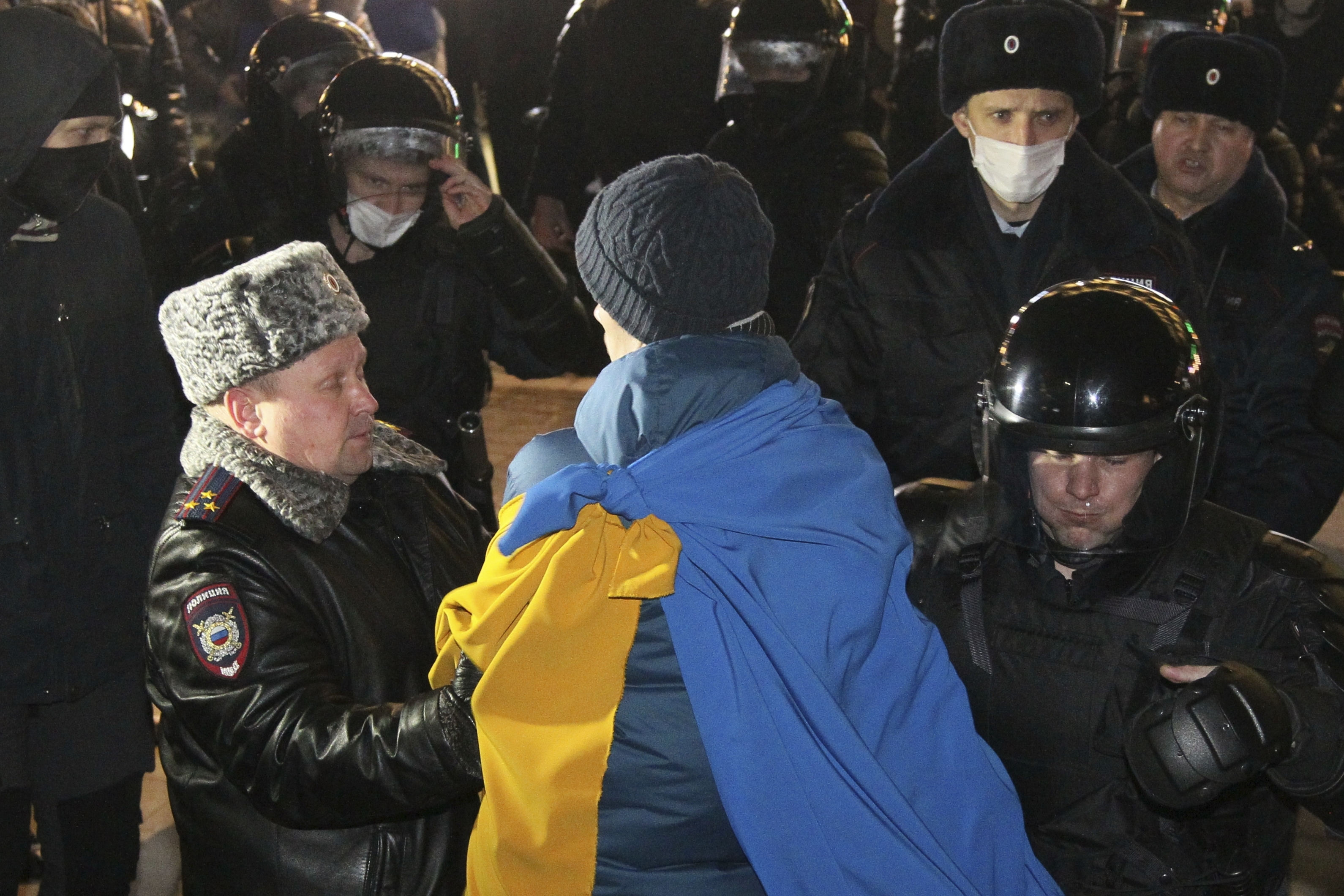 Police officers detain a protester in Nizhny Novgorod, Russia