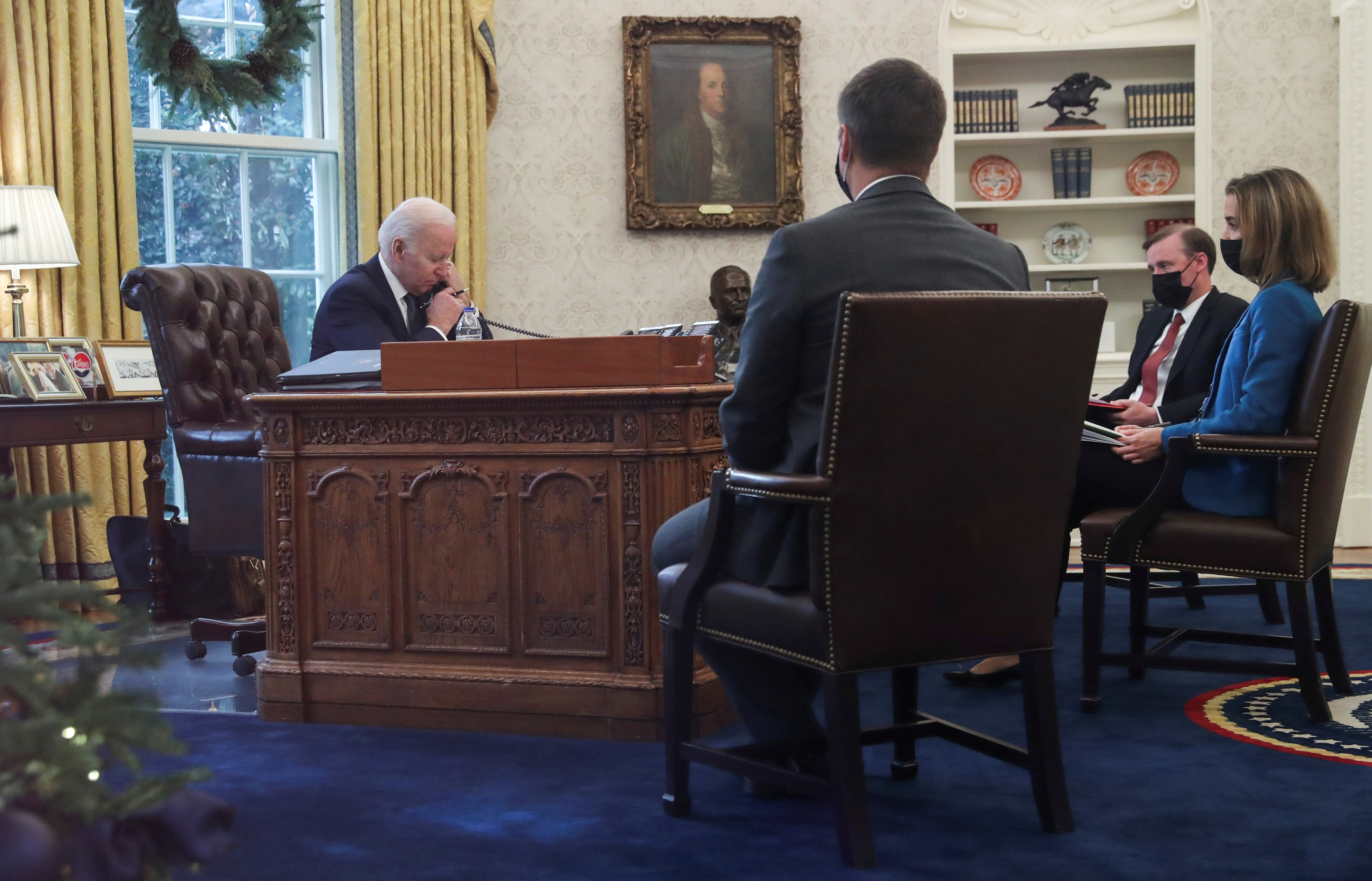 US President Joe Biden is seen in the Oval Office as he speaks by phone with Ukraine's President Volodymyr Zelenskiy