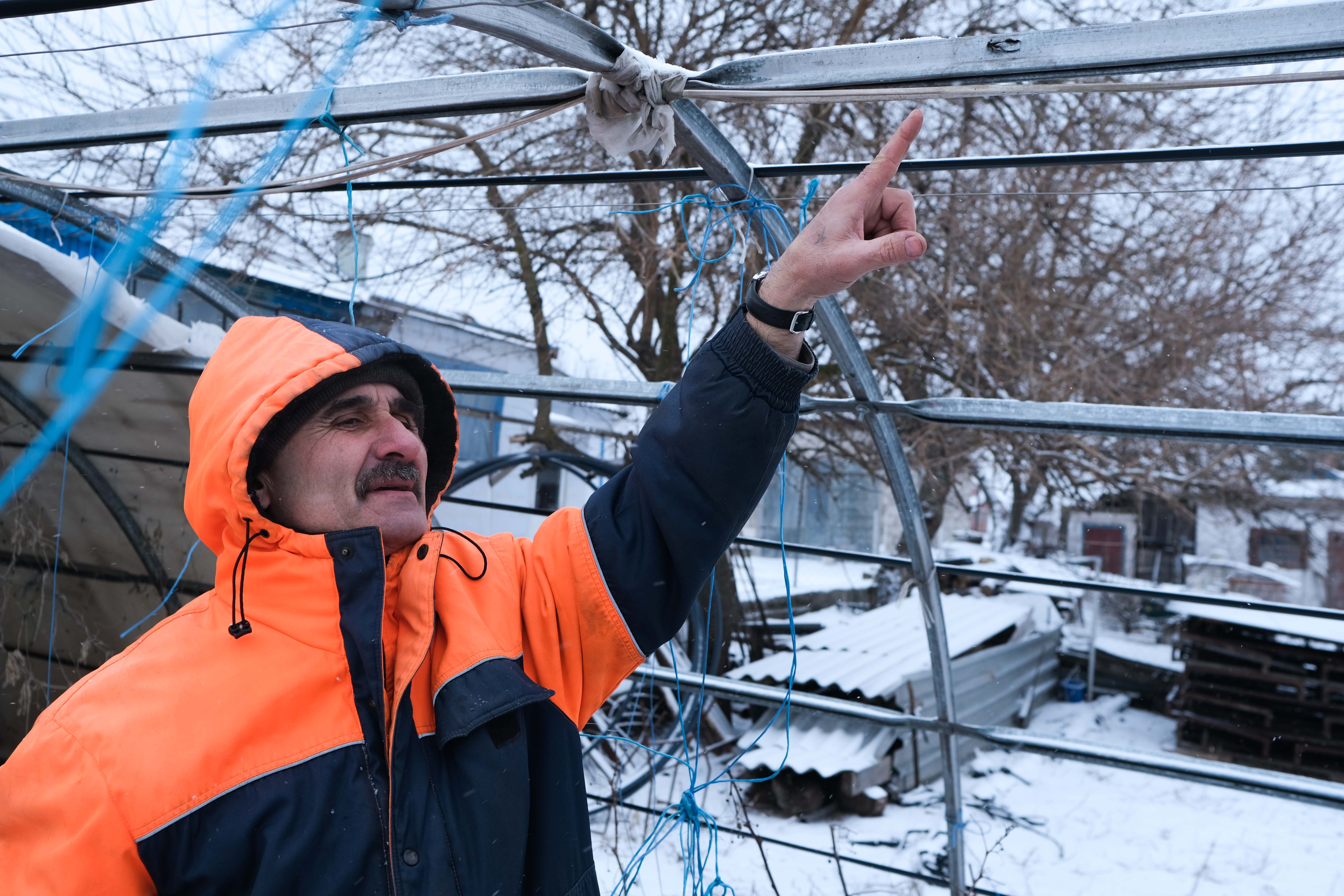 Sergey points to a bullet hole in his garden where the occasionally sporadic gunfire will reach