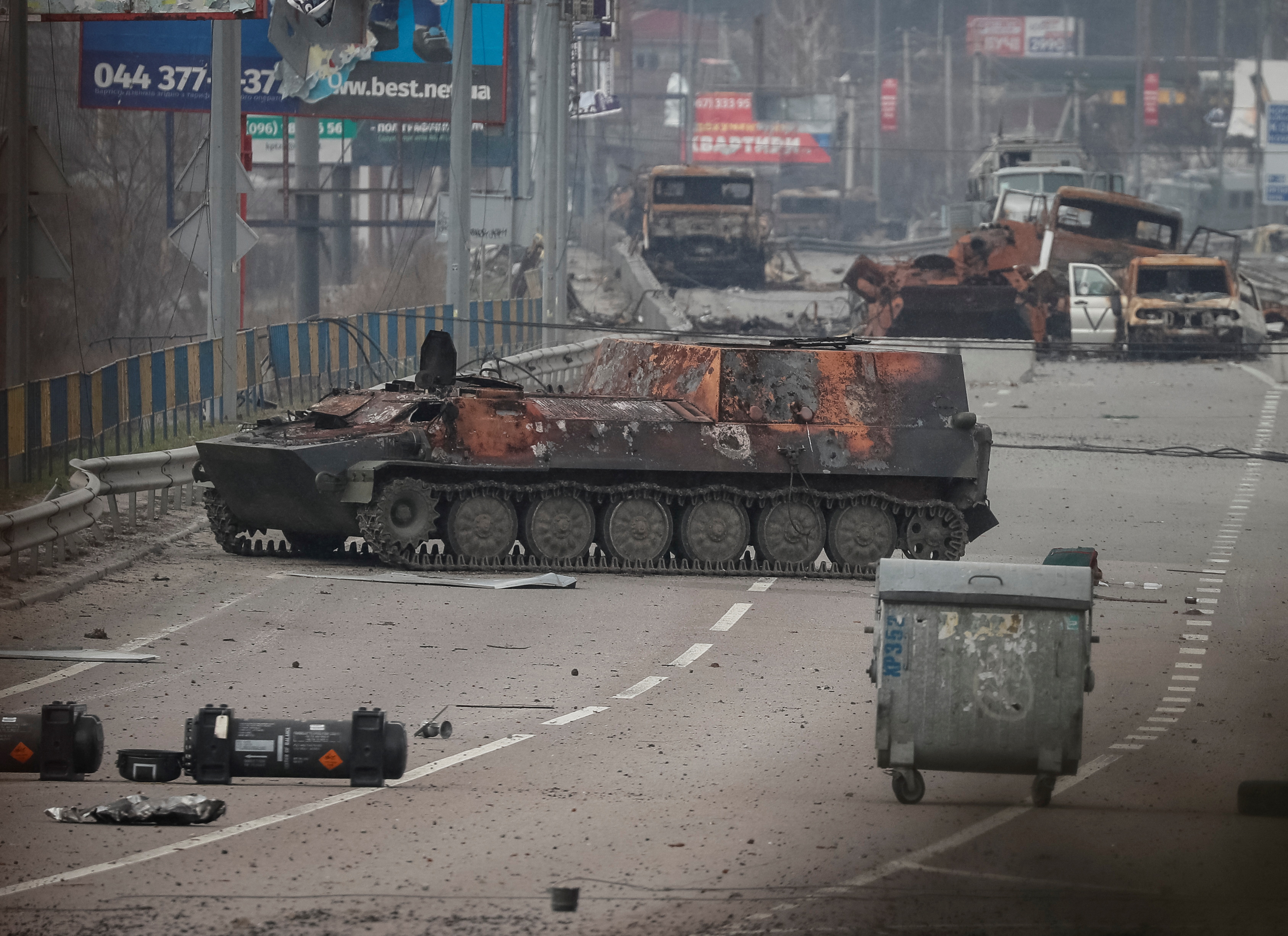 Burned out wrecks of Russian armed personnel carriers are seen along a street near Kyiv
