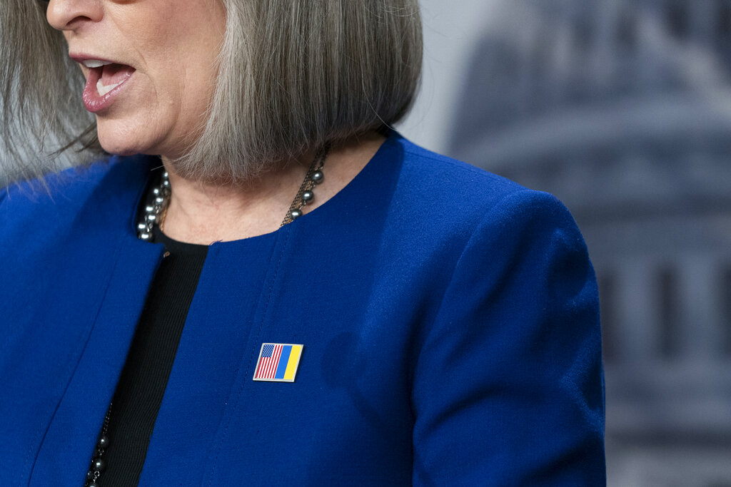 Republican Senator Joni Ernst wears a pin pairing the American red white and blue flag with the Ukrainian blue and yellow to show support for the embattled Eastern European nation