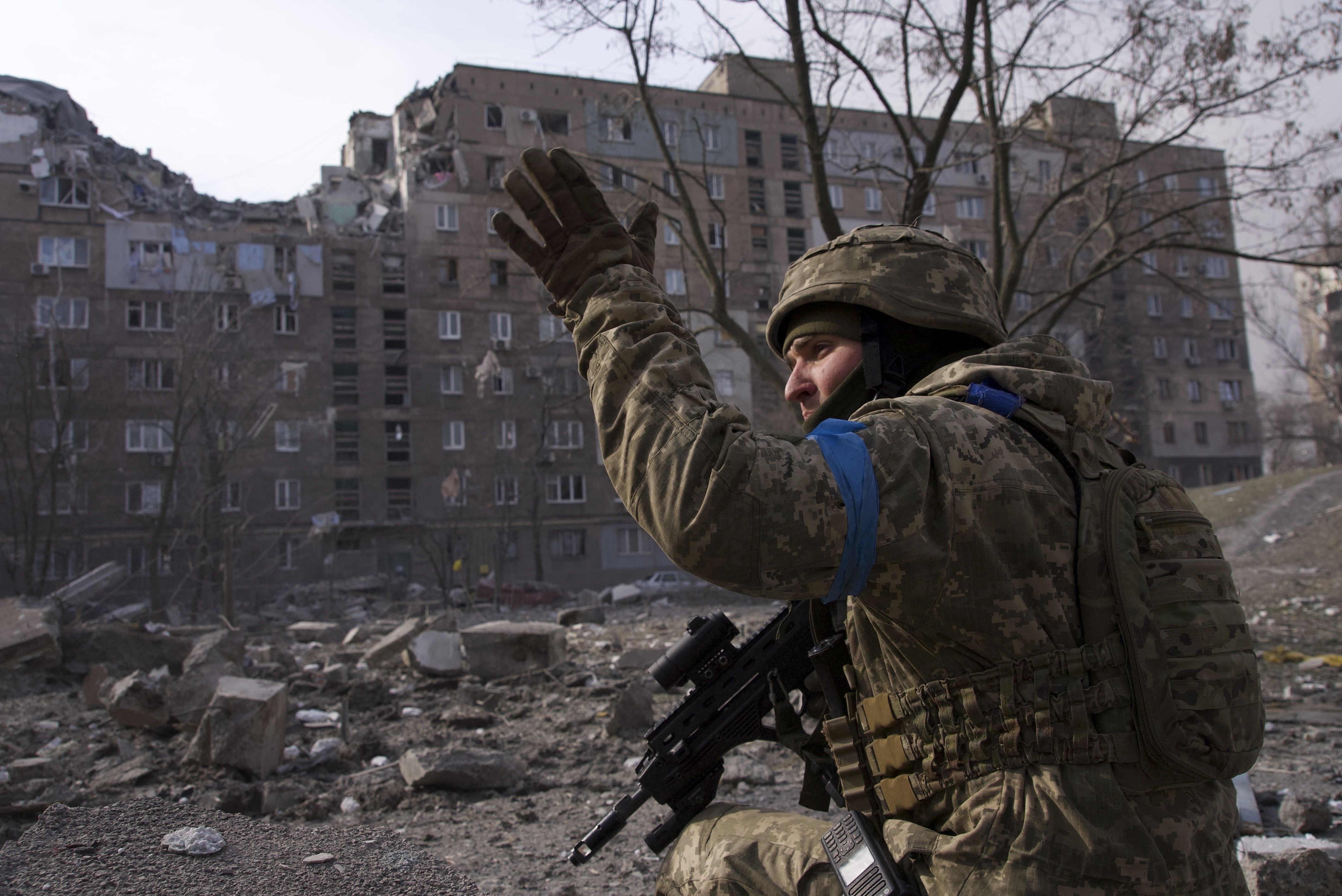 A Ukrainian serviceman guards his position in Mariupol, Ukraine, Saturday, March 12, 2022.