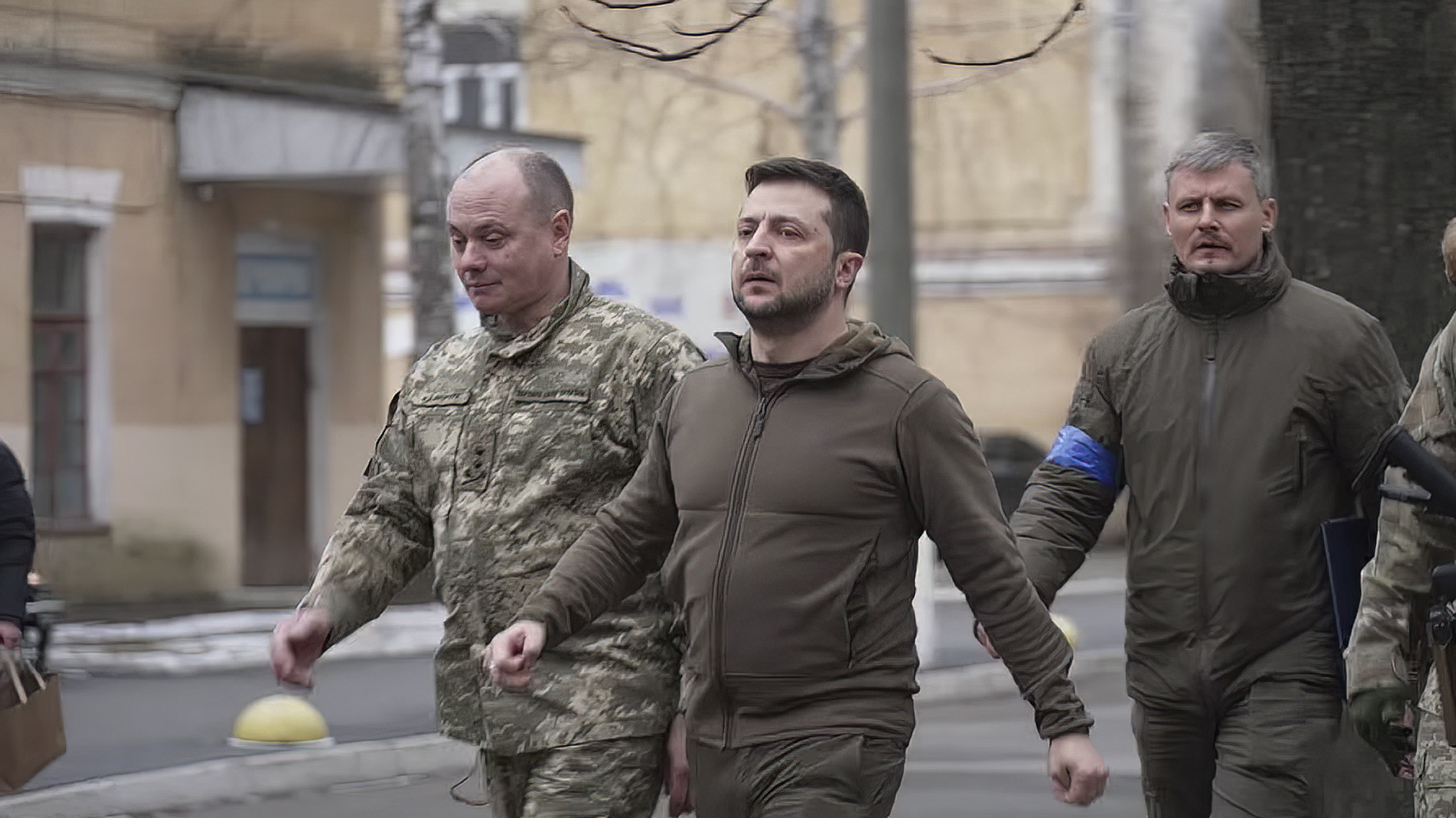 In this image from video provided by the Ukrainian Presidential Press Office and posted on Facebook on Sunday, March 13, 2022, Ukrainian President Volodymyr Zelenskyy walks to a hospital to visit doctors, nurses and wounded military members in Kyiv, Ukraine. (Ukrainian Presidential Press Office via AP)