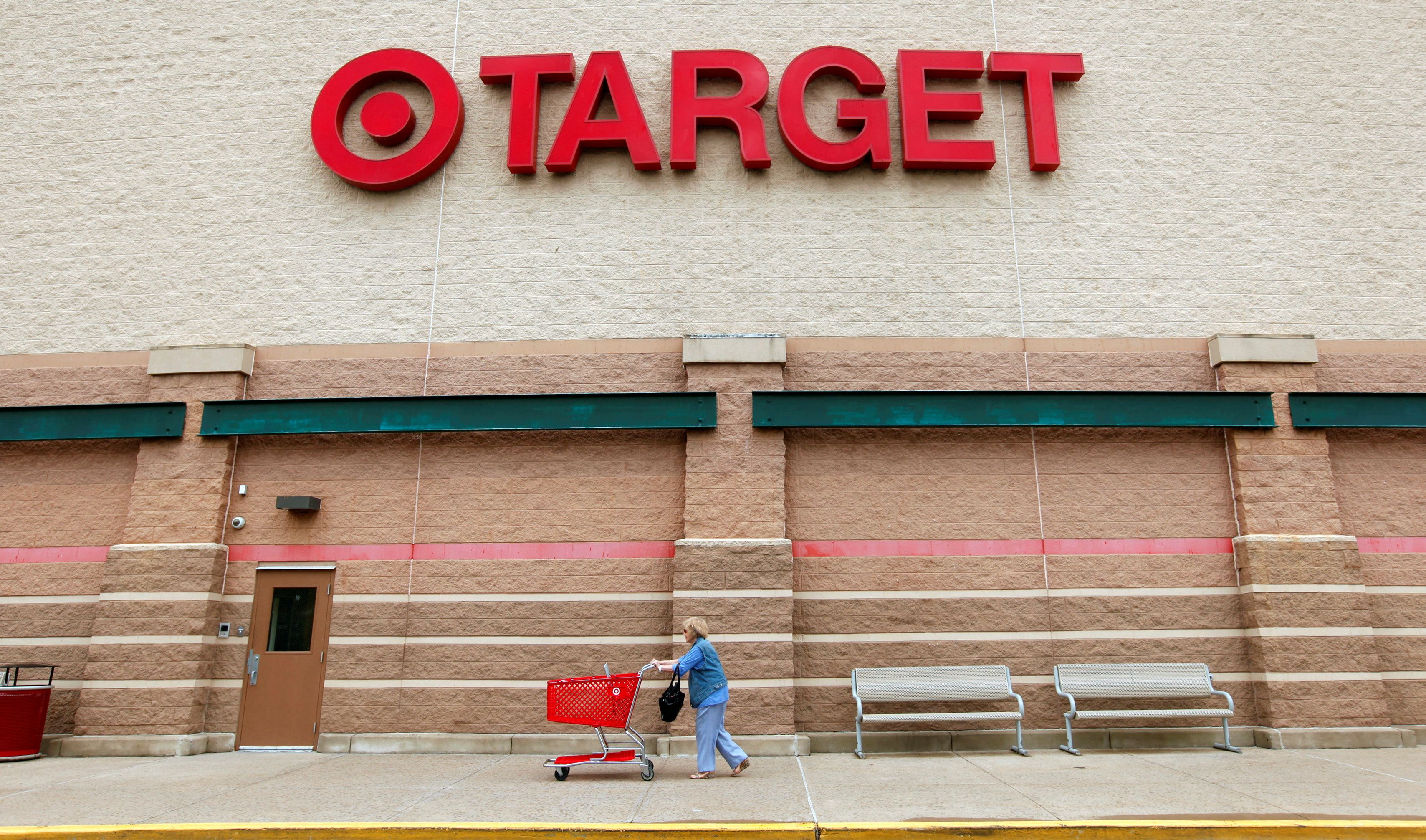 A Target shopper pushes her card outside a store in Falls Church, Virginia