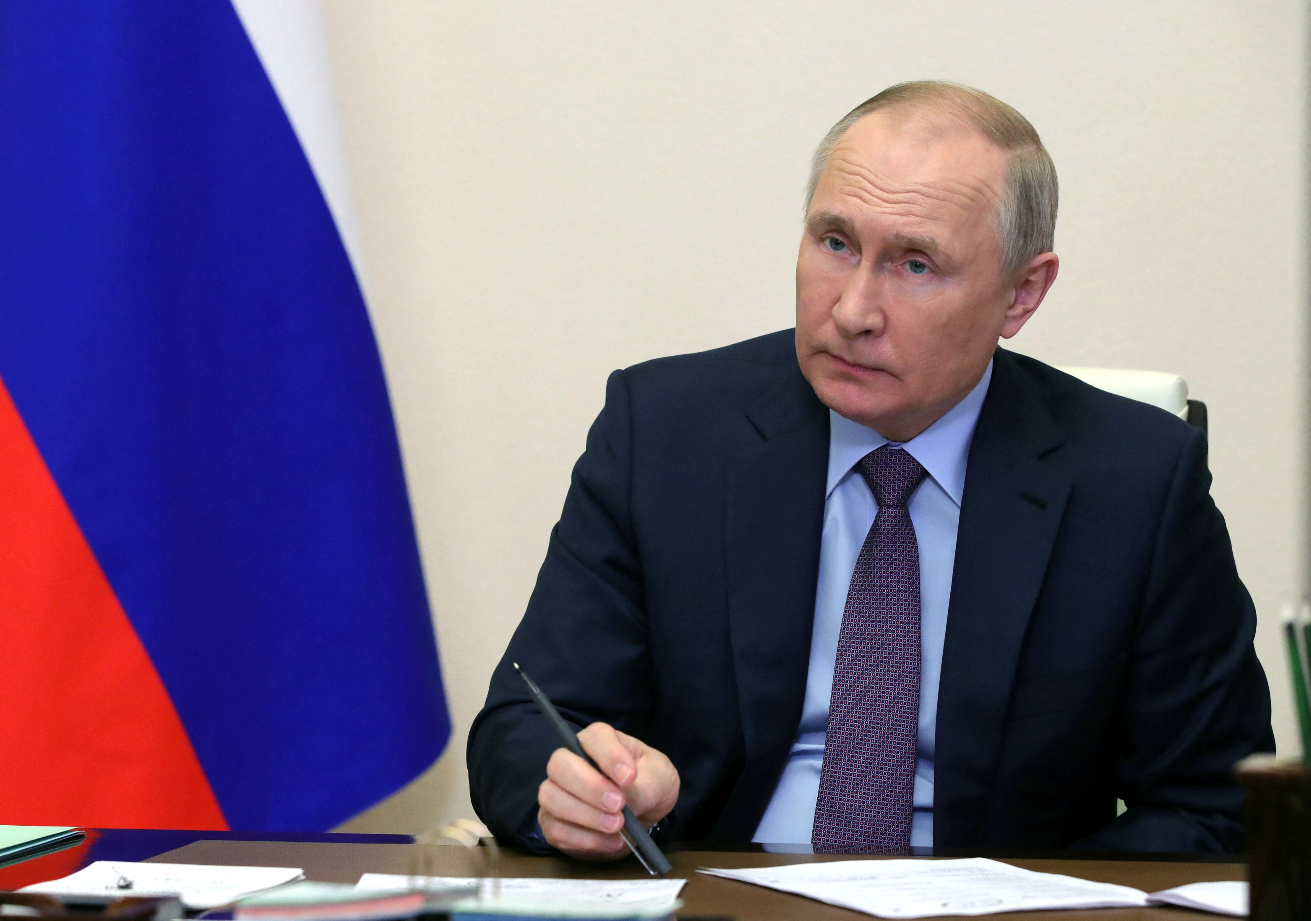 Vladimir Putin chairs a meeting by video link.