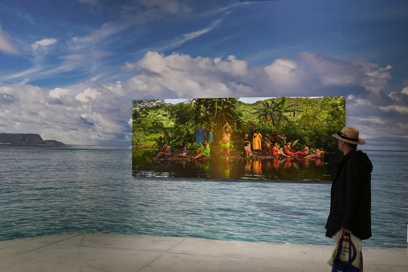 A man looks at the installation Paradise Camp by artist Yuki Kihara
