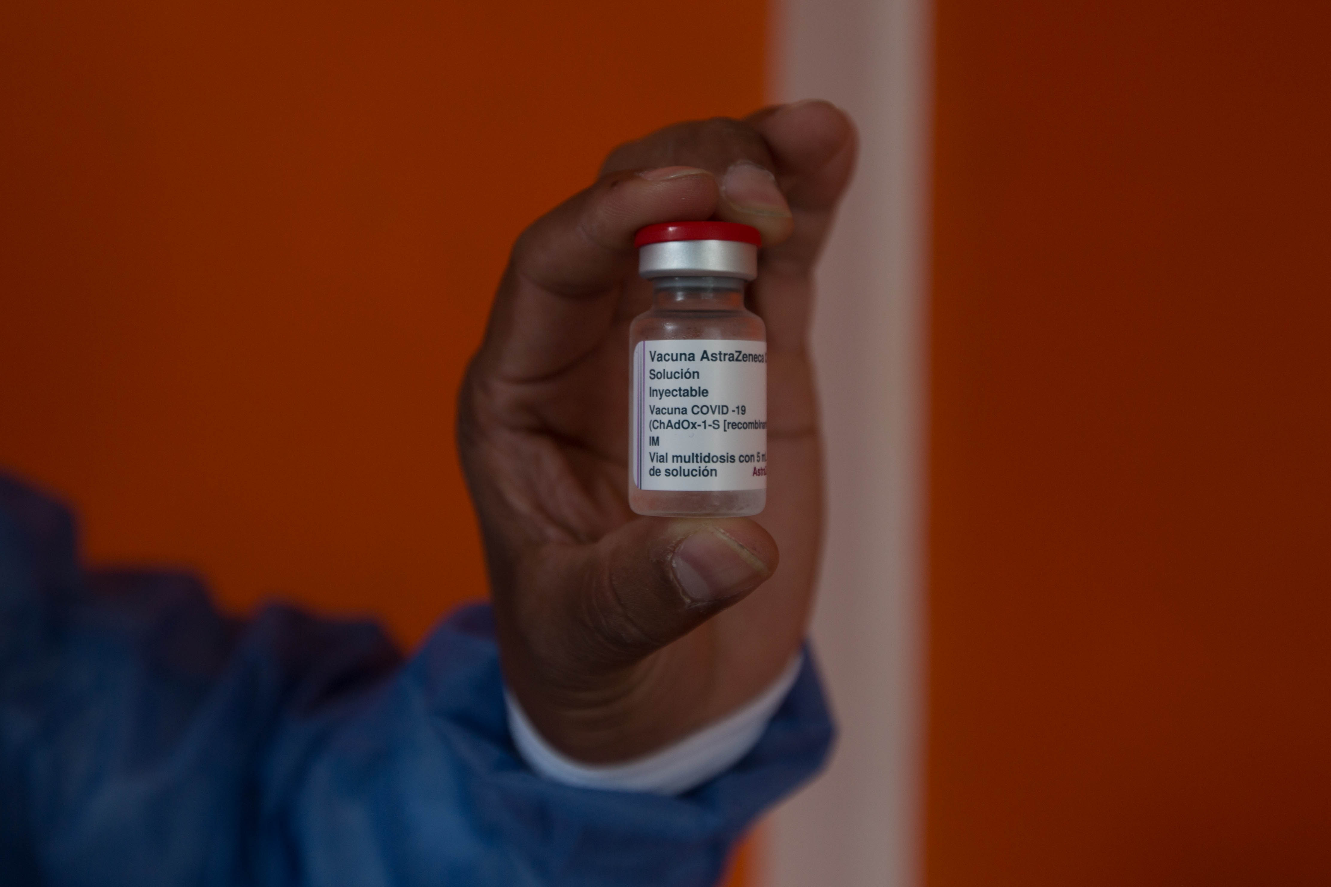 A healthcare worker holds up a vile of the Aztra Zeneca vaccine in Coban Alta Verapaz in March 2022