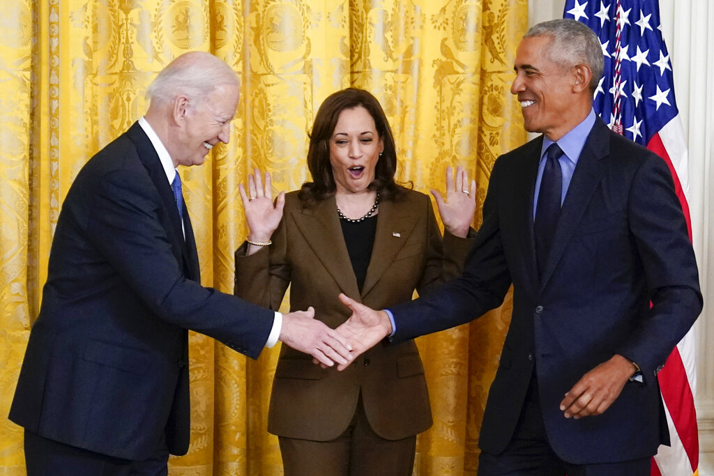 Vice President Kamala Harris reacts as President Joe Biden shakes hands with former President Barack Obama after Obama jokingly called Biden vice president in the East Room of the White House in Washington.