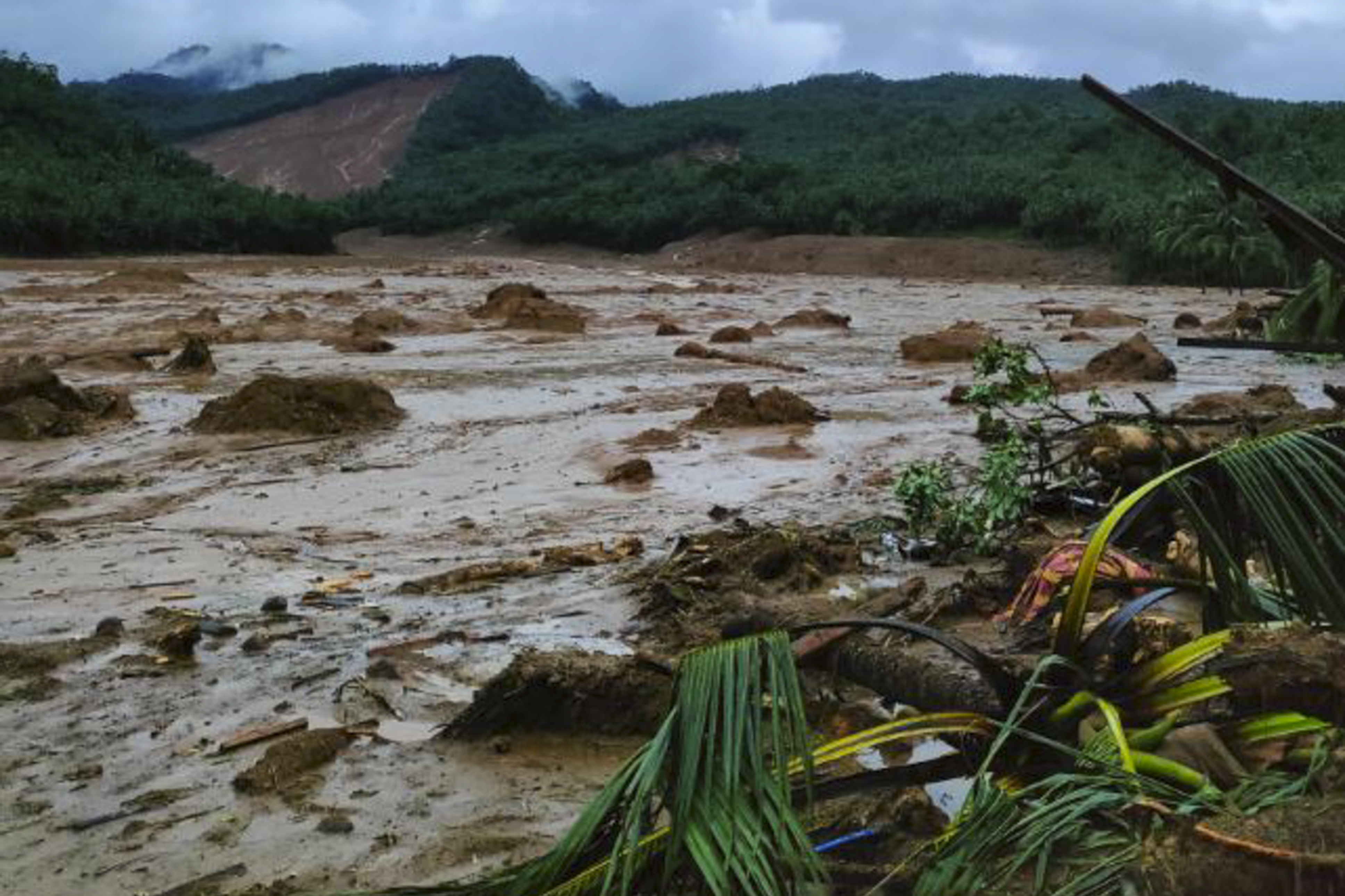 Torrents of muddy, brown water at a landslide area at Baybay City in Leyte province where at least 25 people were killed in tropical storm Megi [Philippine Coast Guard via AP Photo]