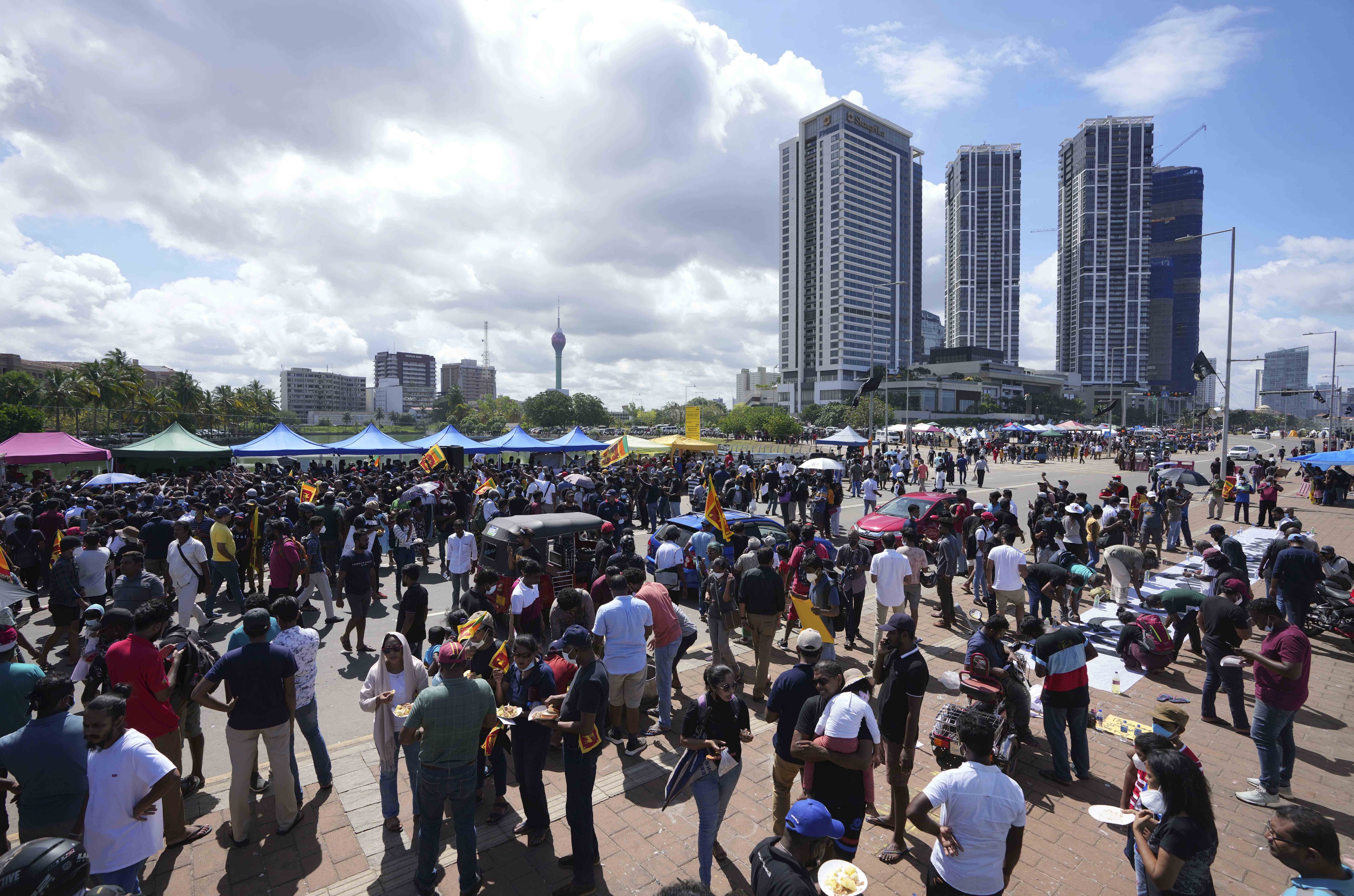 Sri Lankans welcome the dawn of the Sinhalese and Tamil new year at a protest site near the president’s office in Colombo