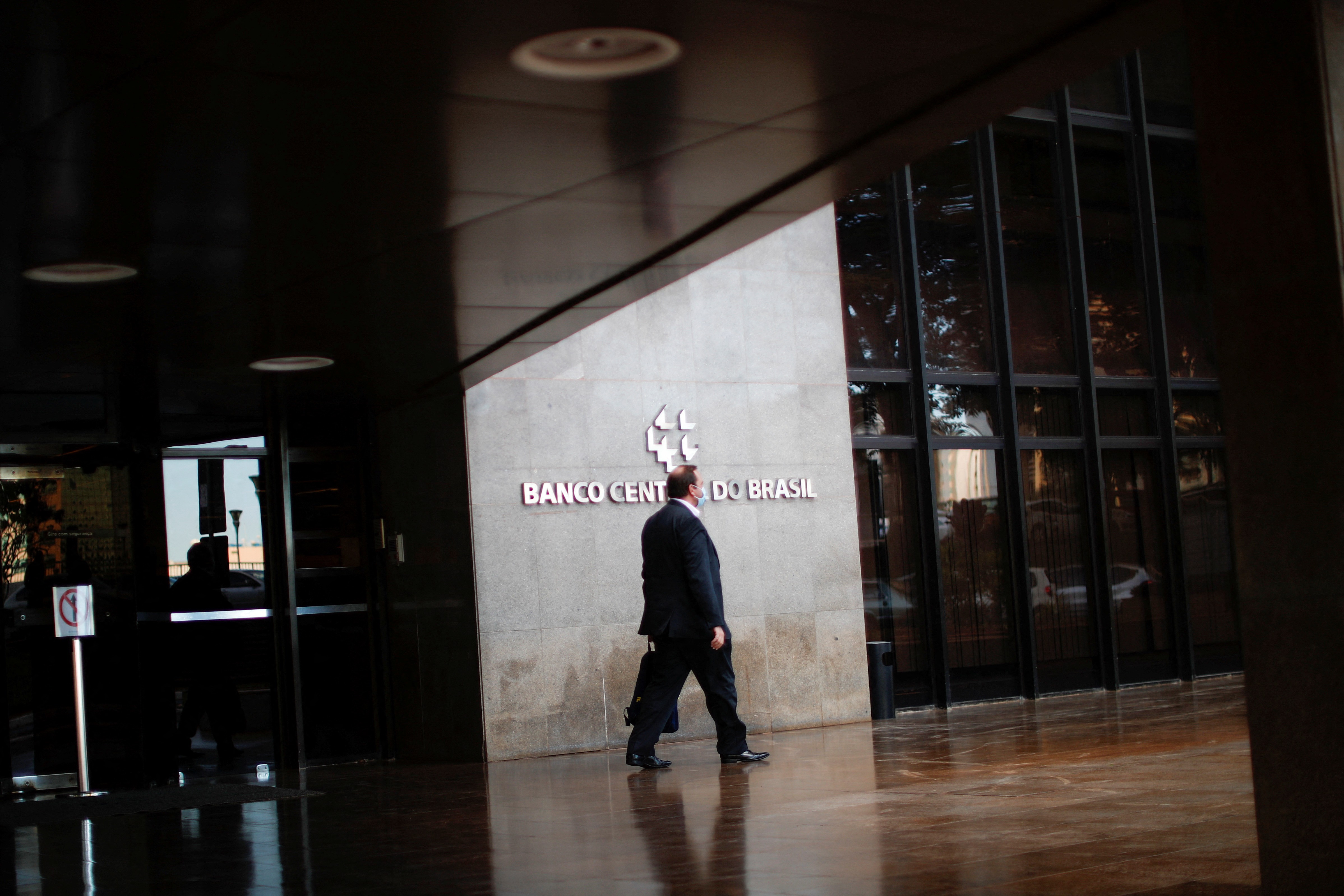 A man walks in front the Central Bank headquarters building in Brasilia, Brazil