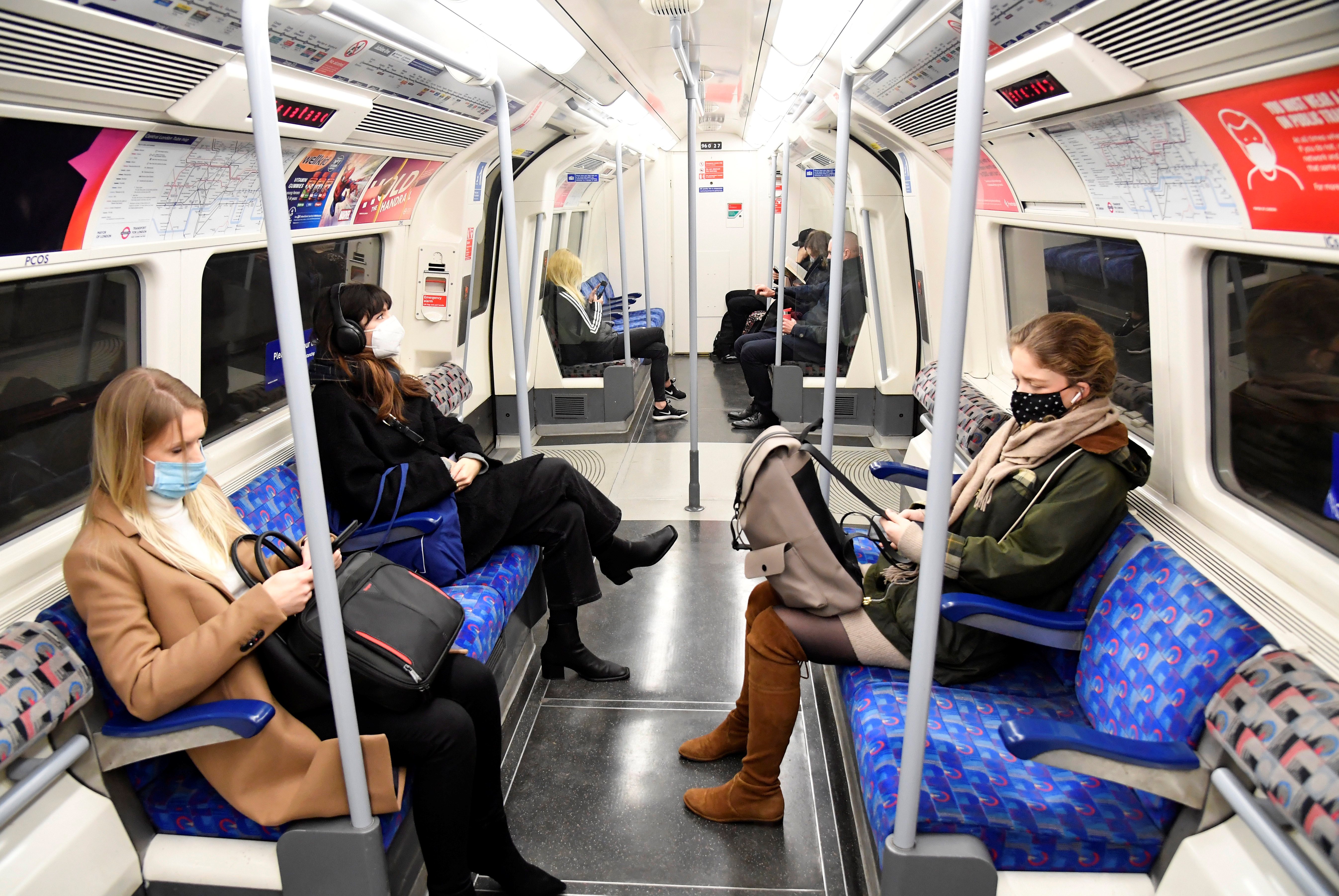 Workers travel on a Jubilee Line underground train during the morning rush-hour, in London, Britain