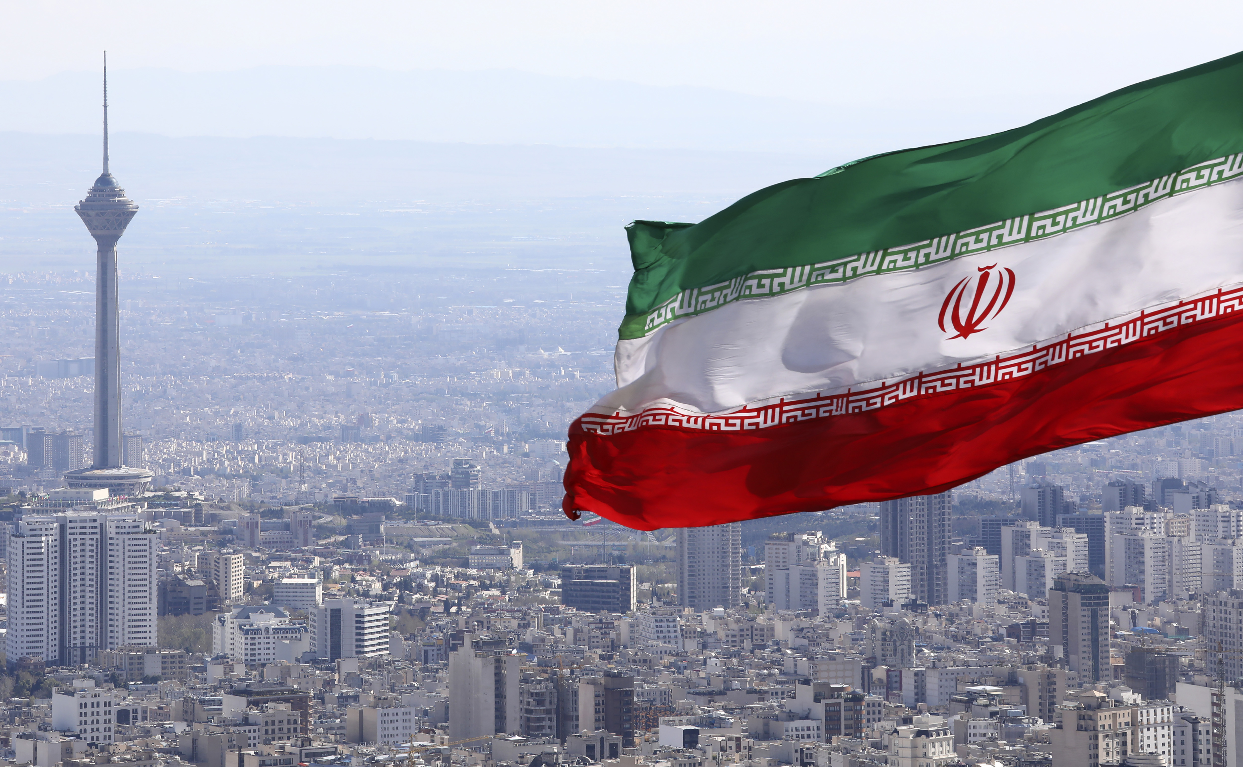 Iran's national flag flying over Tehran.