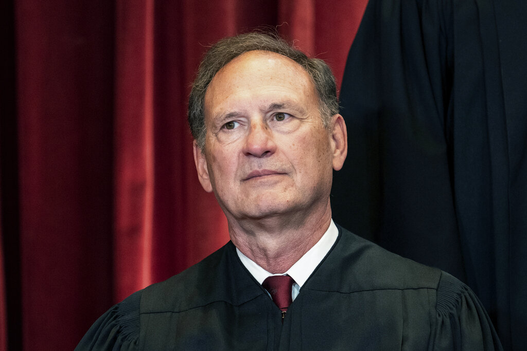Associate Justice Samuel Alito sits during a group photo at the Supreme Court.