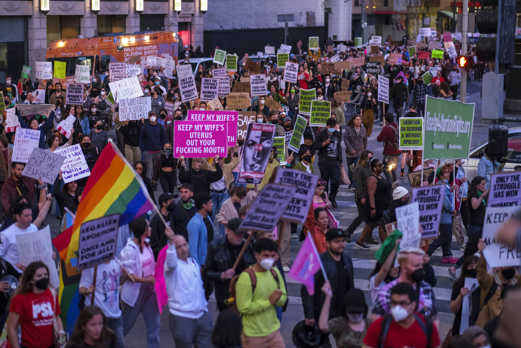Demonstrators march down the streets after protesting outside the US Court
