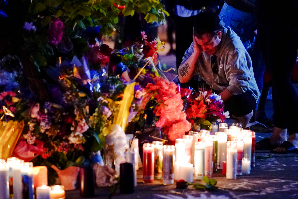 A person pays his respects at a candle vigil set up outside the scene of a shooting at a supermarket, in Buffalo.