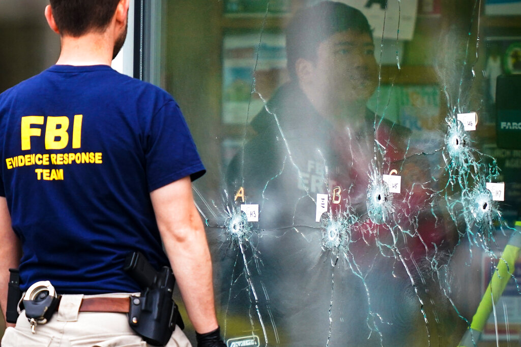 FBI Investigators work the scene of a shooting at a supermarket, in Buffalo, N.Y.