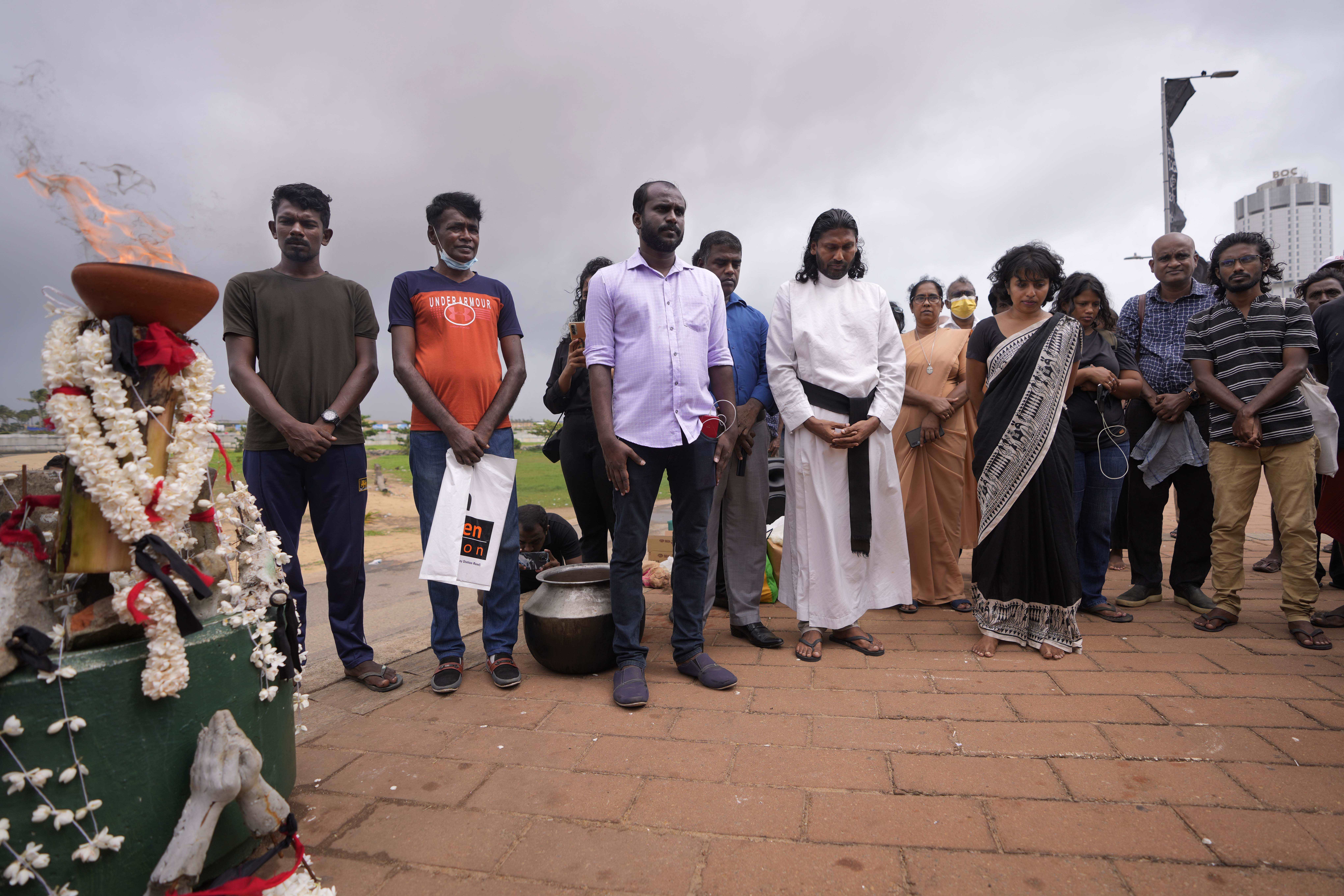 Human rights activists observe a minute of silence in remembrance of victims of Sri Lanka's civil war.