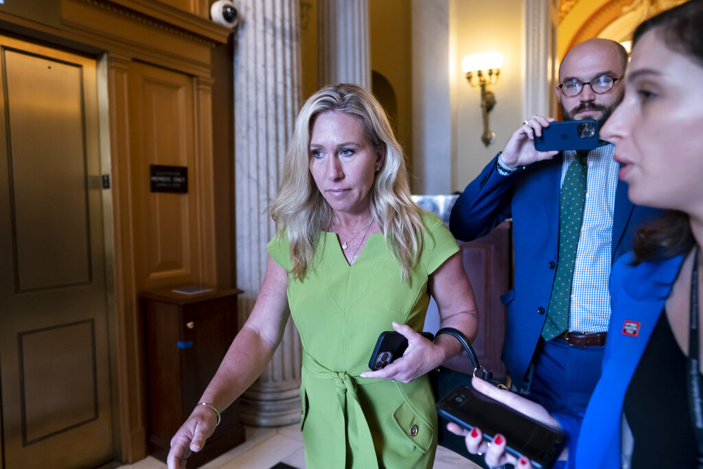 Rep. Marjorie Taylor Greene, R-Ga., departs the House chamber at the end of votes, at the Capitol in Washington.