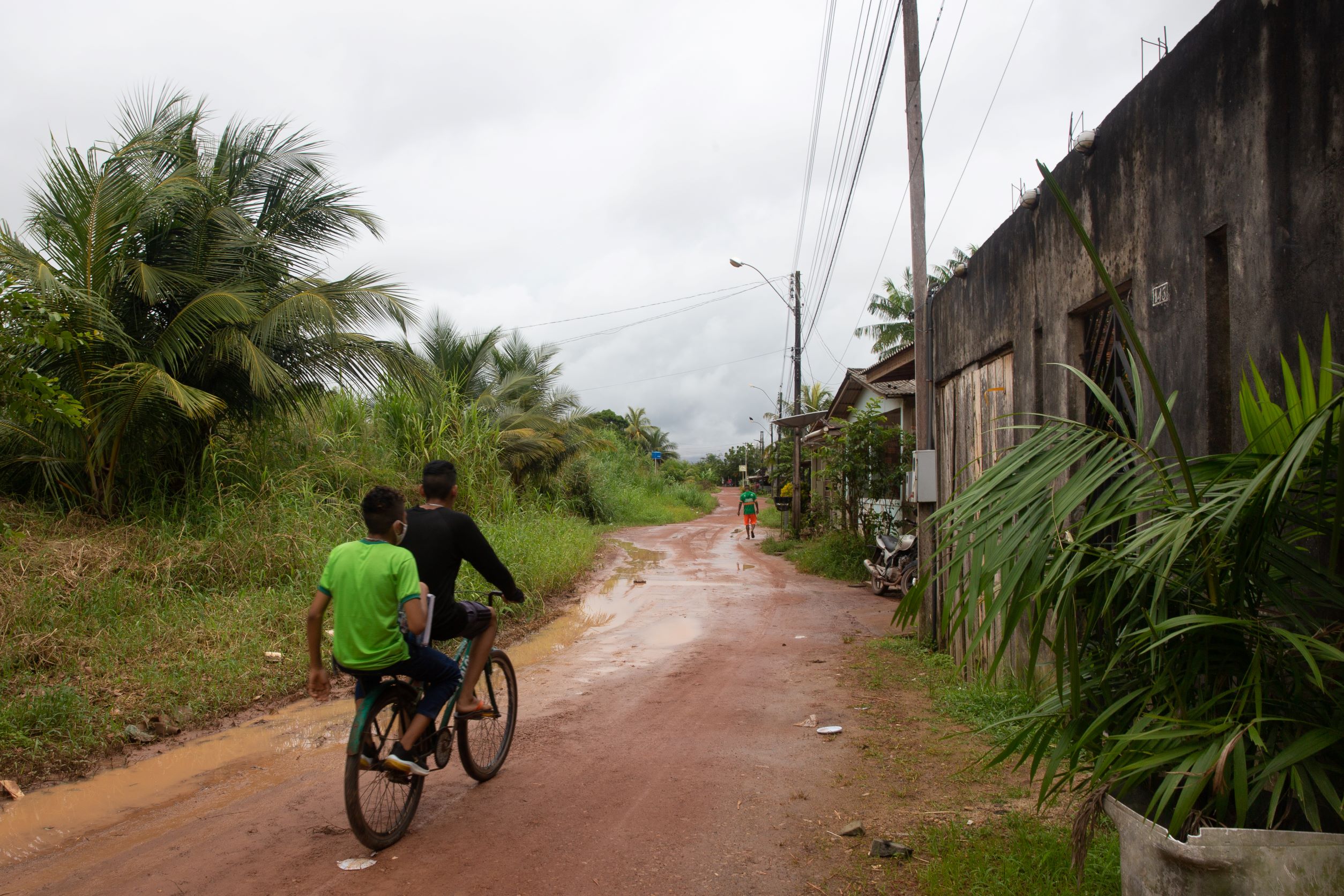 Kids bike down a road in Santana, Brazil