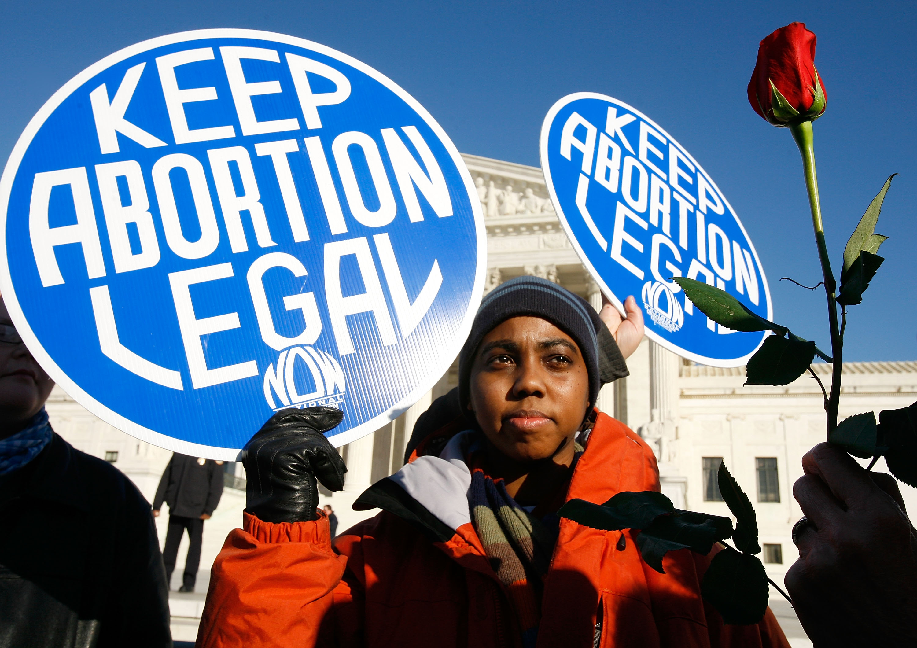 An activist holds a banner that reads "keep abortion legal" in front of the US Supreme Court