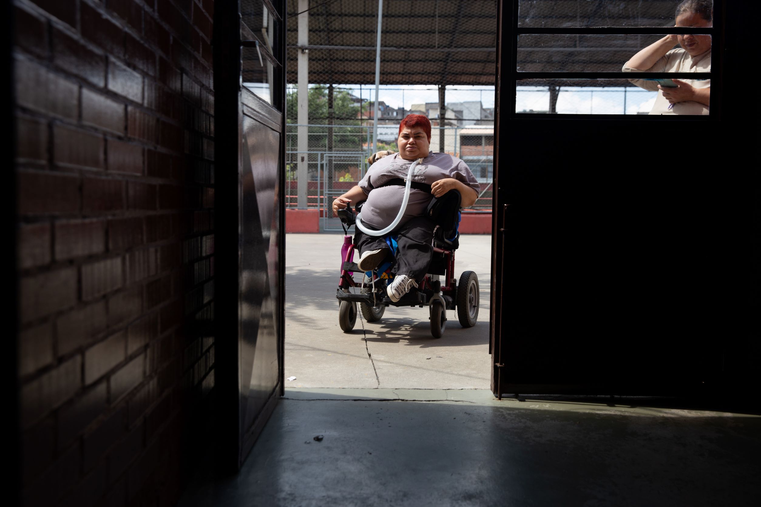 Polio survivor Eliana Gonçalves moves through the school where she lives