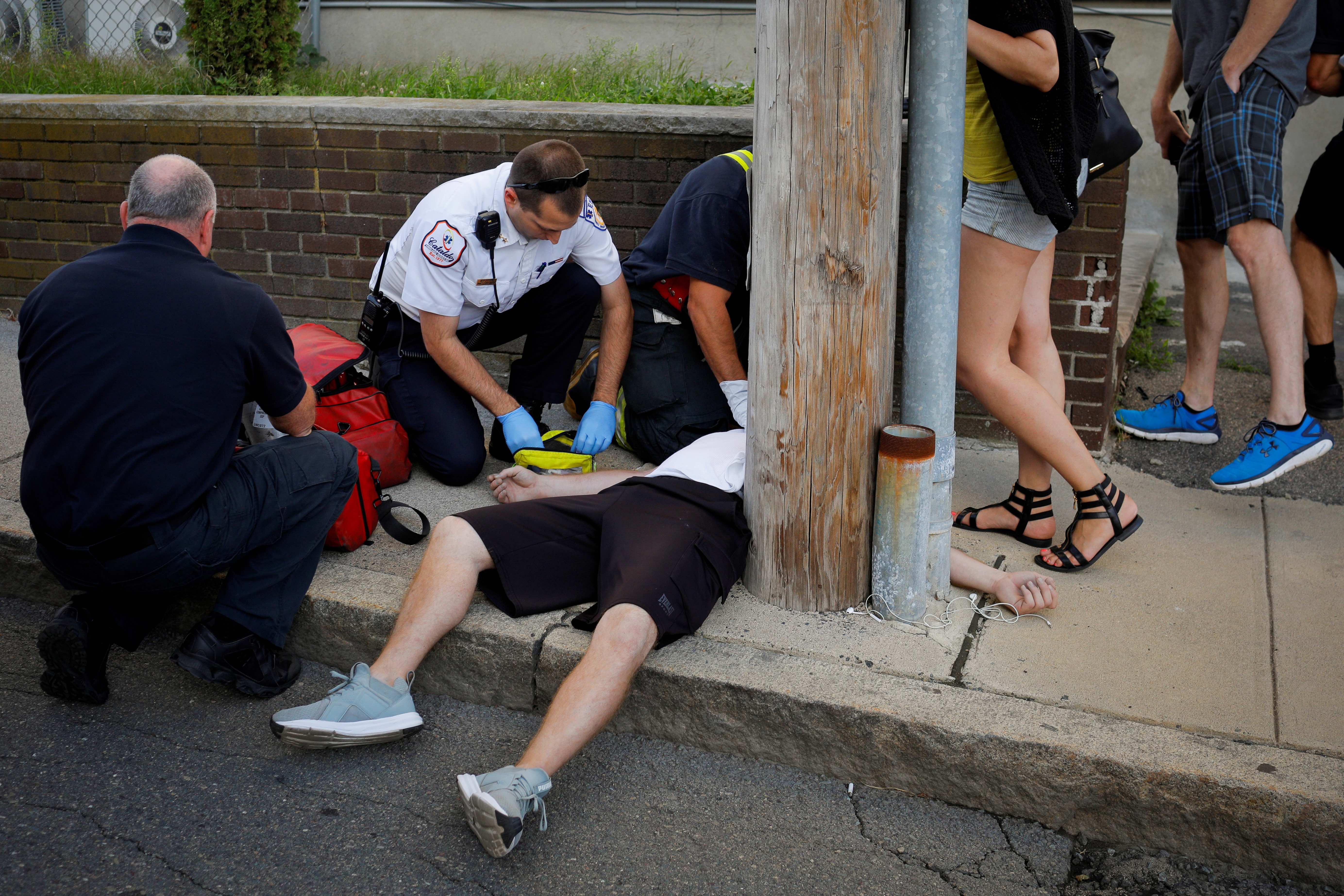 Medics revive a man who was found unresponsive and not breathing after an opioid overdose on a sidewalk in the Boston suburb of Everett, Massachusetts, U.S.