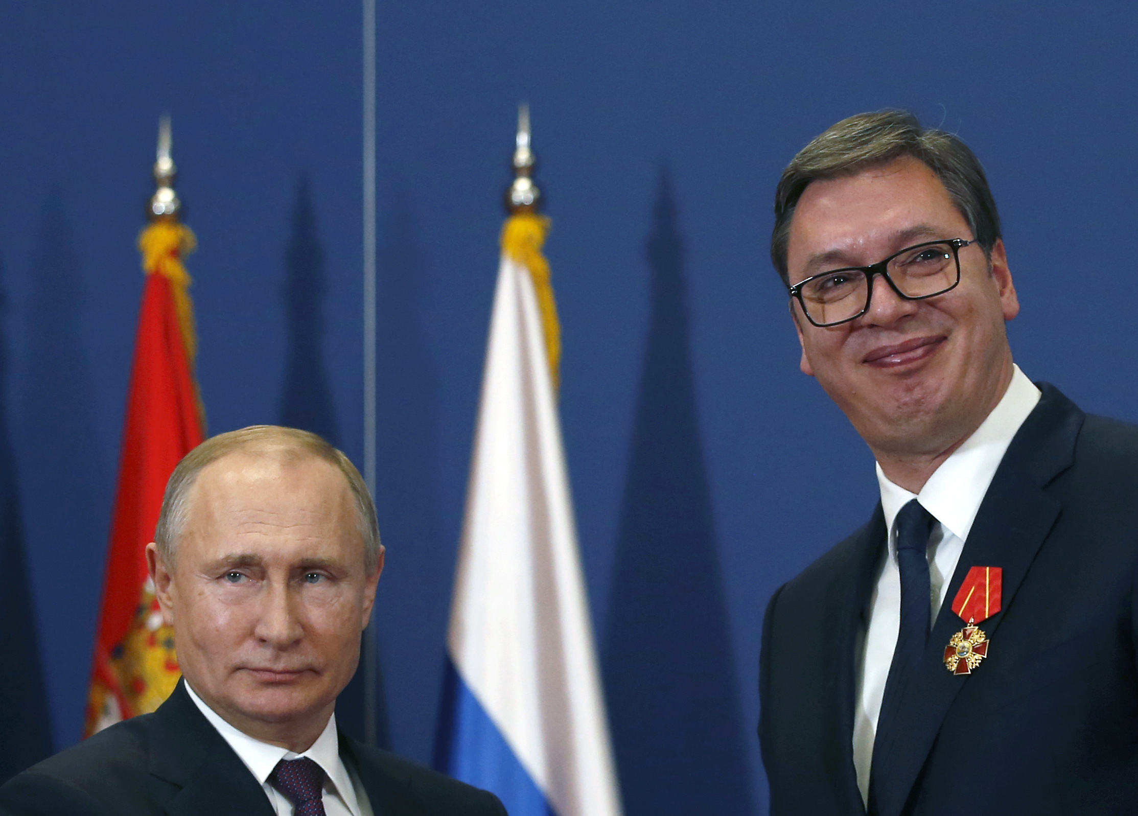 Russian President Vladimir Putin, (left), poses with Serbian President Aleksandar Vucic after being awarded the Order of Alexander Nevsky in Belgrade, Serbia, Thursday, Jan. 17, 2019