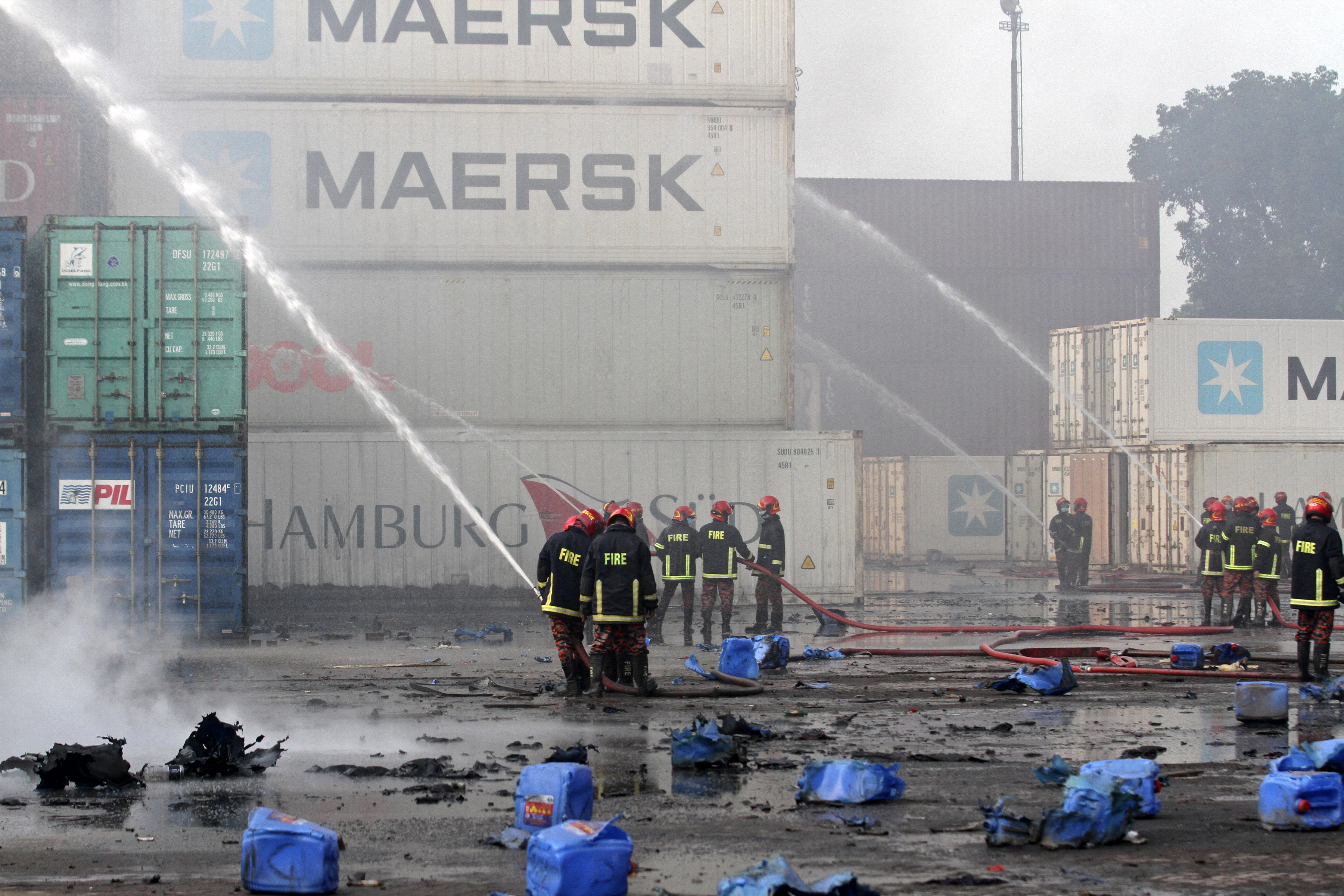 Firefighters try to extinguish a fire