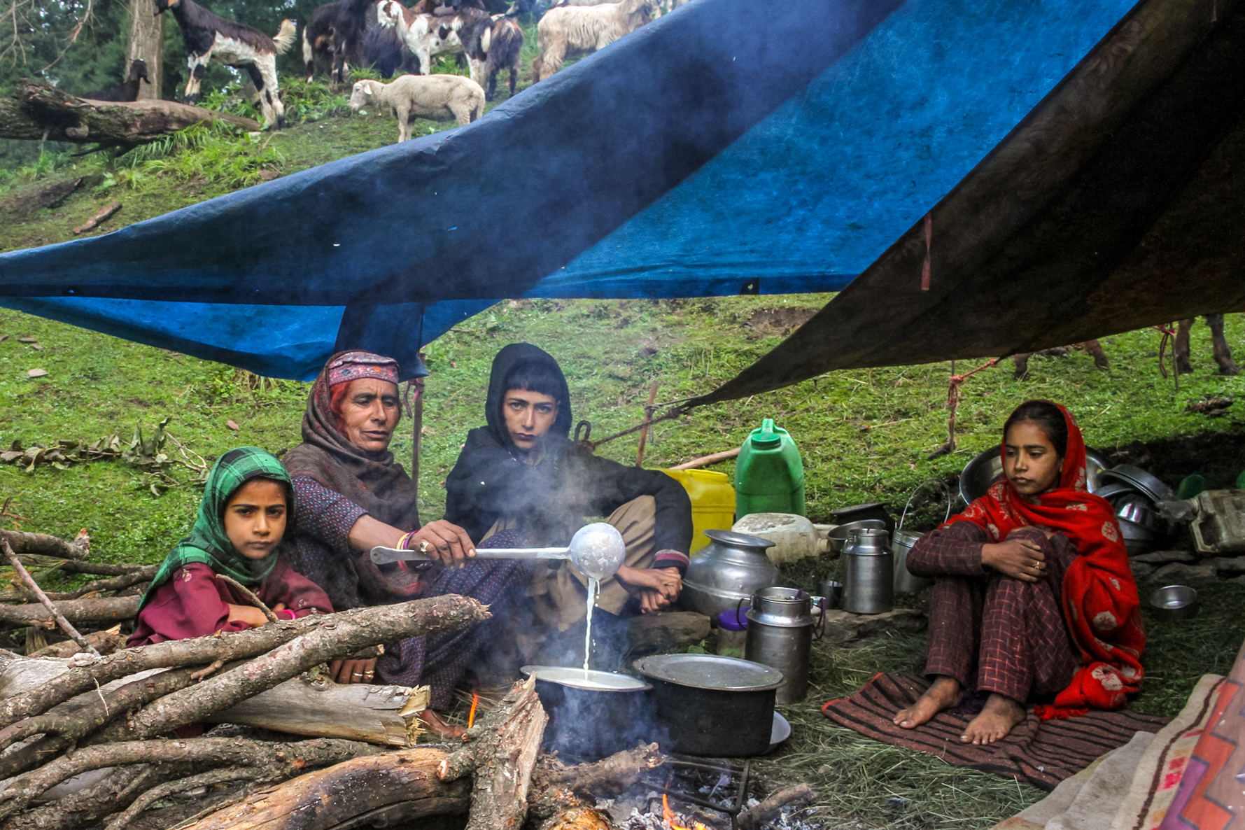 Ban Bargat stirs the kudan mixture as her daughters look on. She wants her daughters to observe the process so they can pick up the skill of making kudan from her mother, just as she did