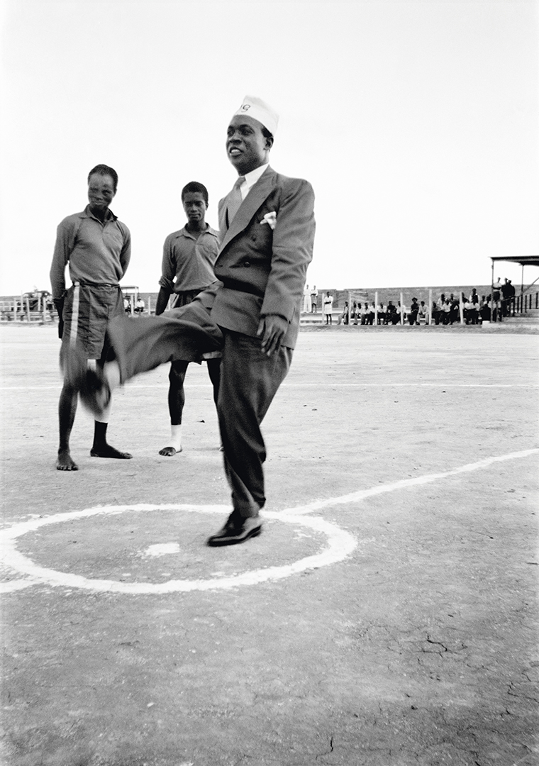 Kwame Nkrumah in his PG (prison graduate) cap, kicking a football before the start of an international match at Owusu Memorial Park in Fadama, Accra, c. 1952