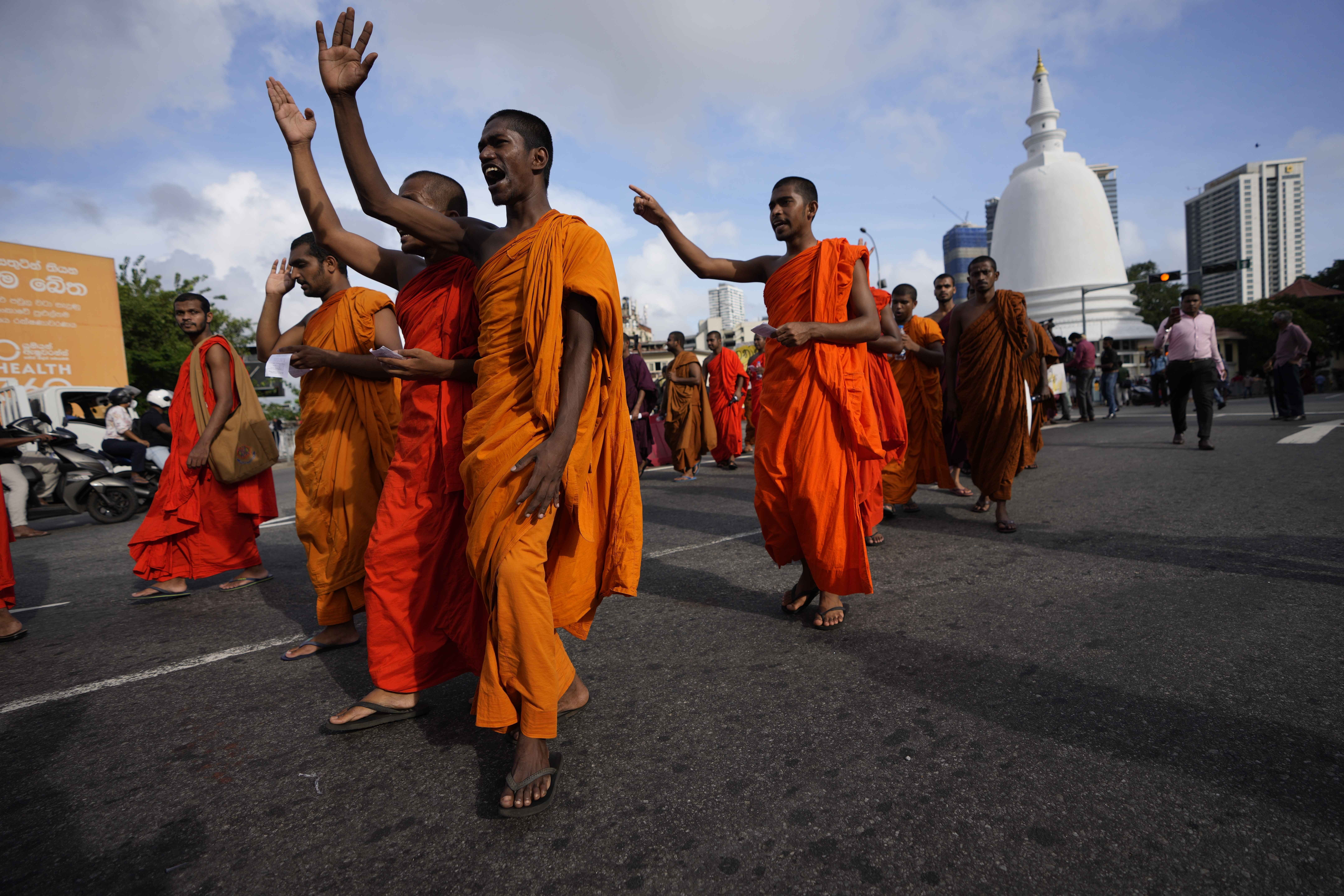 Sri Lankan student Buddhist monks shout slogans as they march demanding President Gotabaya Rajapaksa resign