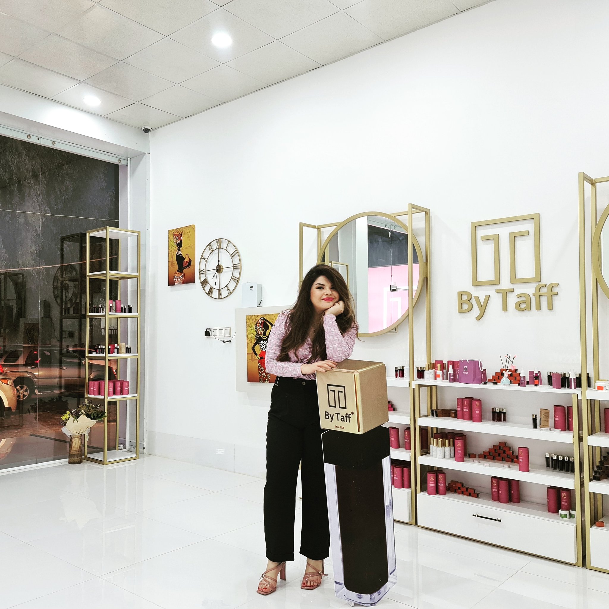 A woman stands in a shop selling cosmetics